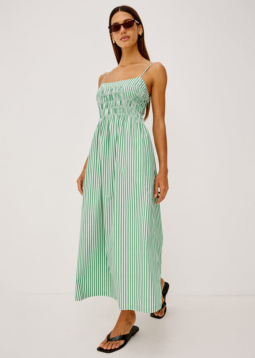 Woman in a green and white striped dress 