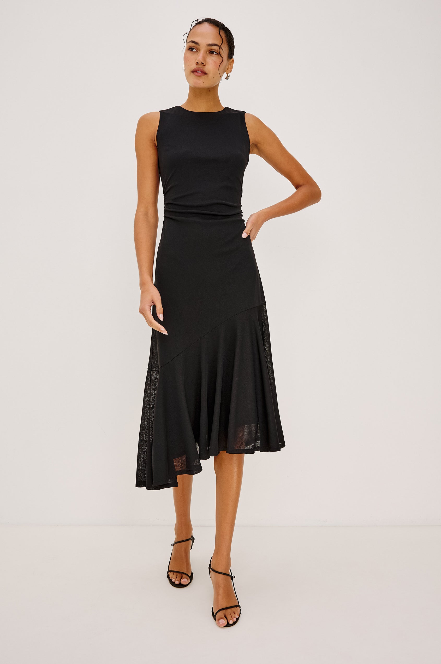 Daija Midi Dress in Compact Mesh With High Neckline, Gathered Waist, and Asymmetrical A-Line Skirt in Black Colorway - Full Body Front View Featured on Model