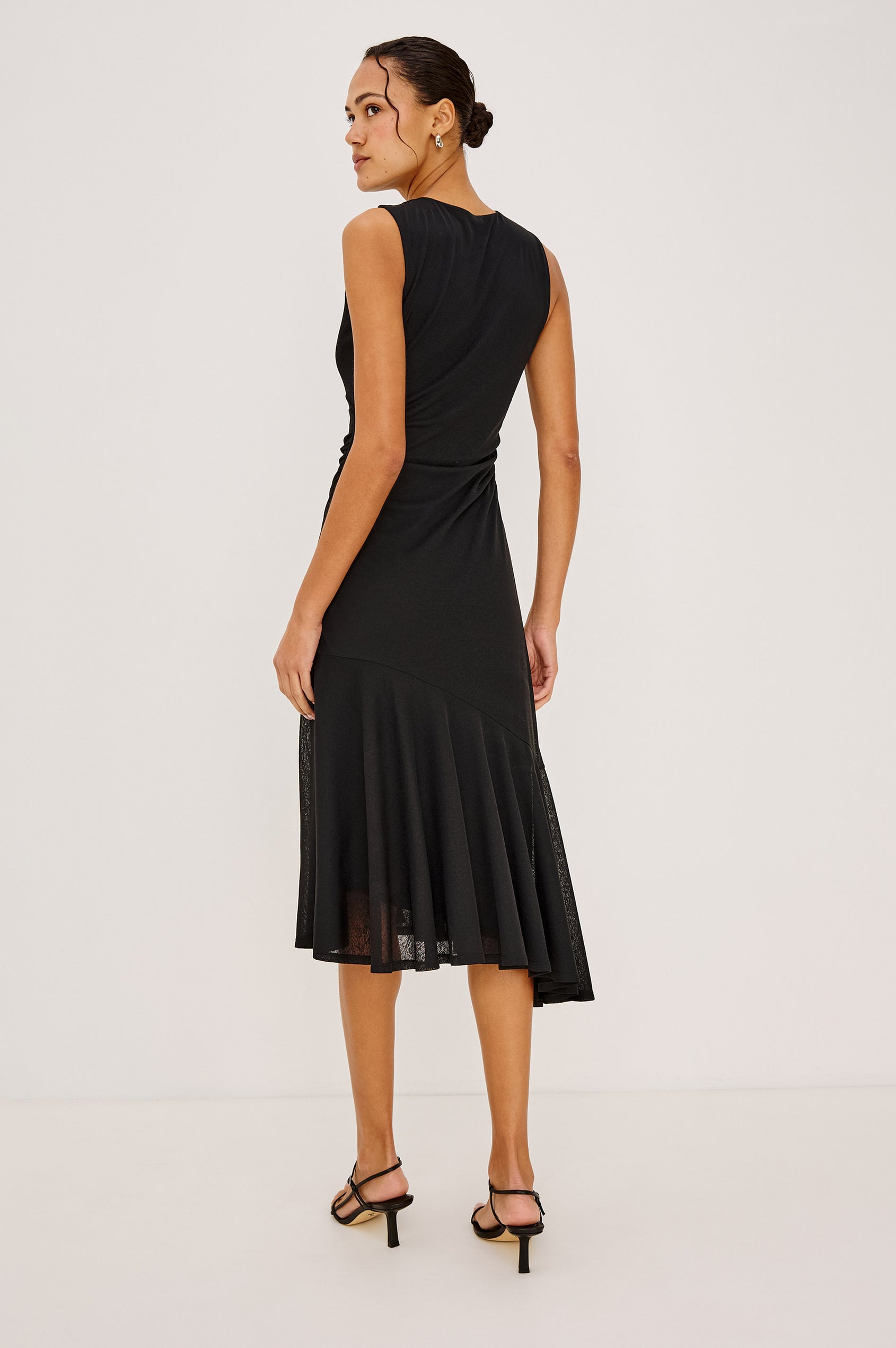 Daija Midi Dress in Compact Mesh With High Neckline, Gathered Waist, and Asymmetrical A-Line Skirt in Black Colorway - Full Body Back View Featured on Model