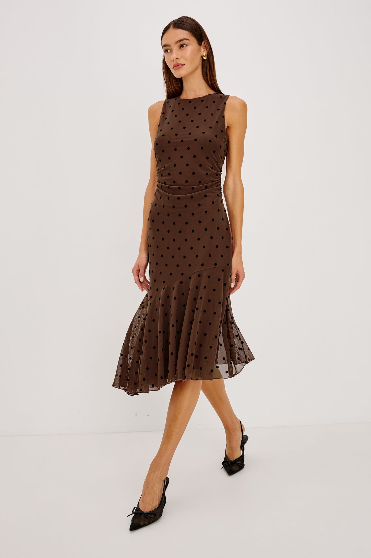 Daija Midi Dress in Self-Lined Mesh With High Neckline, Fitted Bodice, Side Waist Ruching, Bias Cut Skirt, and Asymmetric Hem in Chocolate Polka Dot Colorway - Full Body Front View Featured on Model