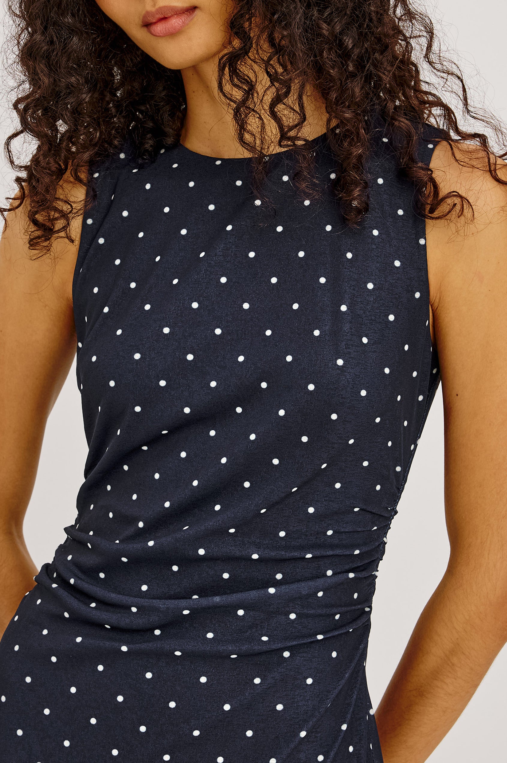 Daija Midi Dress in Self-Lined Mesh With High Neckline, Fitted Bodice, Side Waist Ruching, Bias Cut Skirt, and Asymmetric Hem in Chocolate Polka Dot Colorway - Upper Body Front View Featured on Model