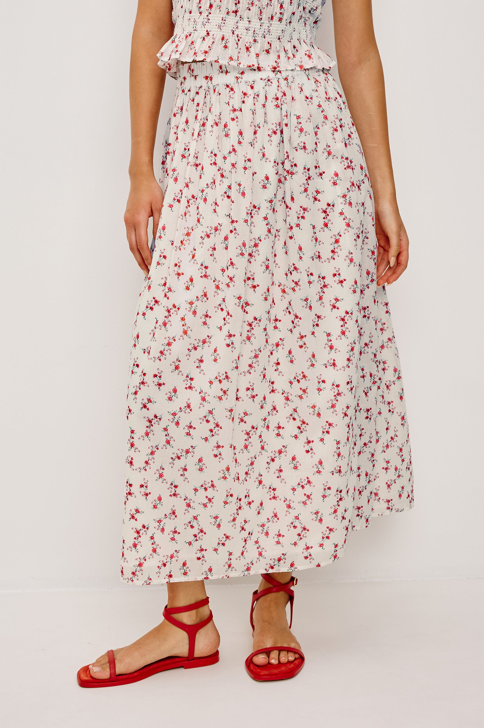 Dax A-Line Maxi Skirt With Grid and Floral Cutwork Embroidery Elastic Waistband and is Fully Lined in Berry Hibiscus Floral Embroidery Colorway - Lower Body Front View Featured on Model