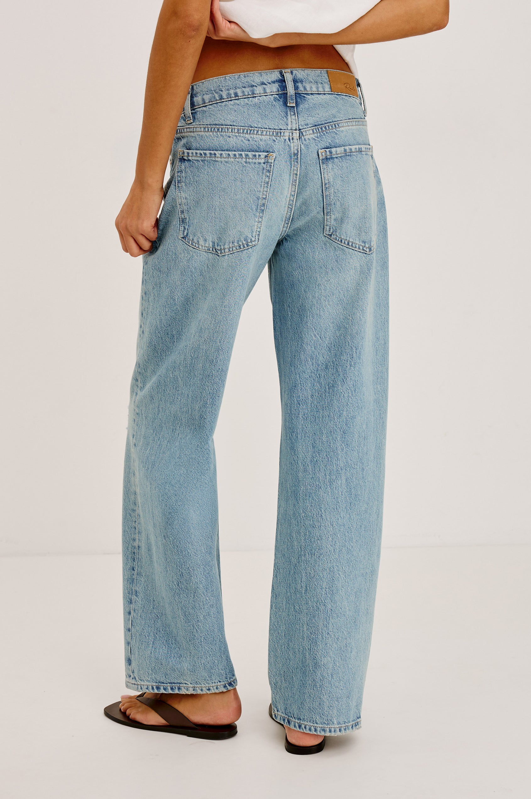 Petite Del Mar Boyfriend Jean With Wide, Relaxed Legs, Distressed Knee and Detailing, and 5-Pocket Vintage-Inspired Design, and Button Fly in Heritage Destructed Colorway - Lower Body Back View Featured on Model