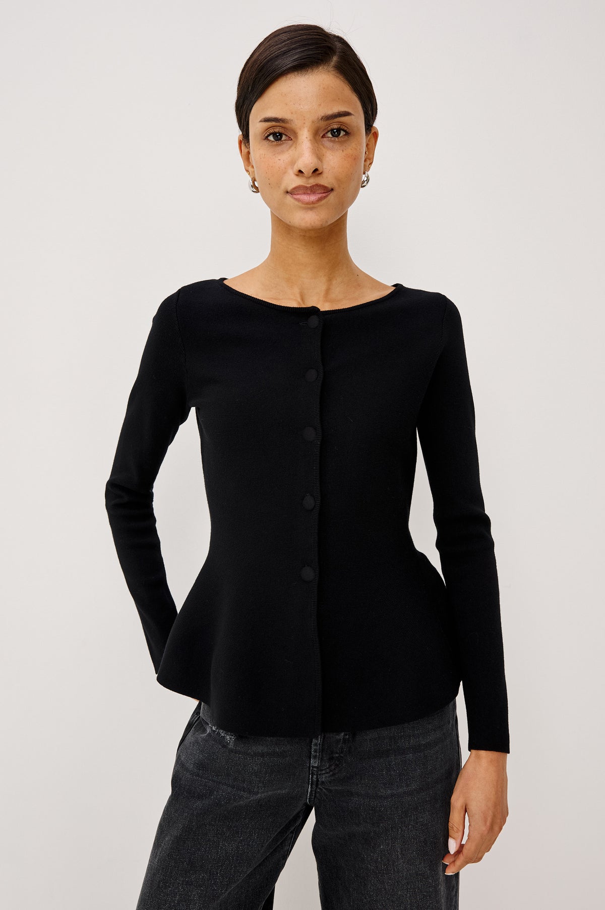 Diane Cardigan in Fine-Gauge Knit With Fitted Body, Peplum Hem, Round Neckline, and Center Front Placket With Self-Covered Buttons in Black Colorway - Upper Body Front View Featured on Model