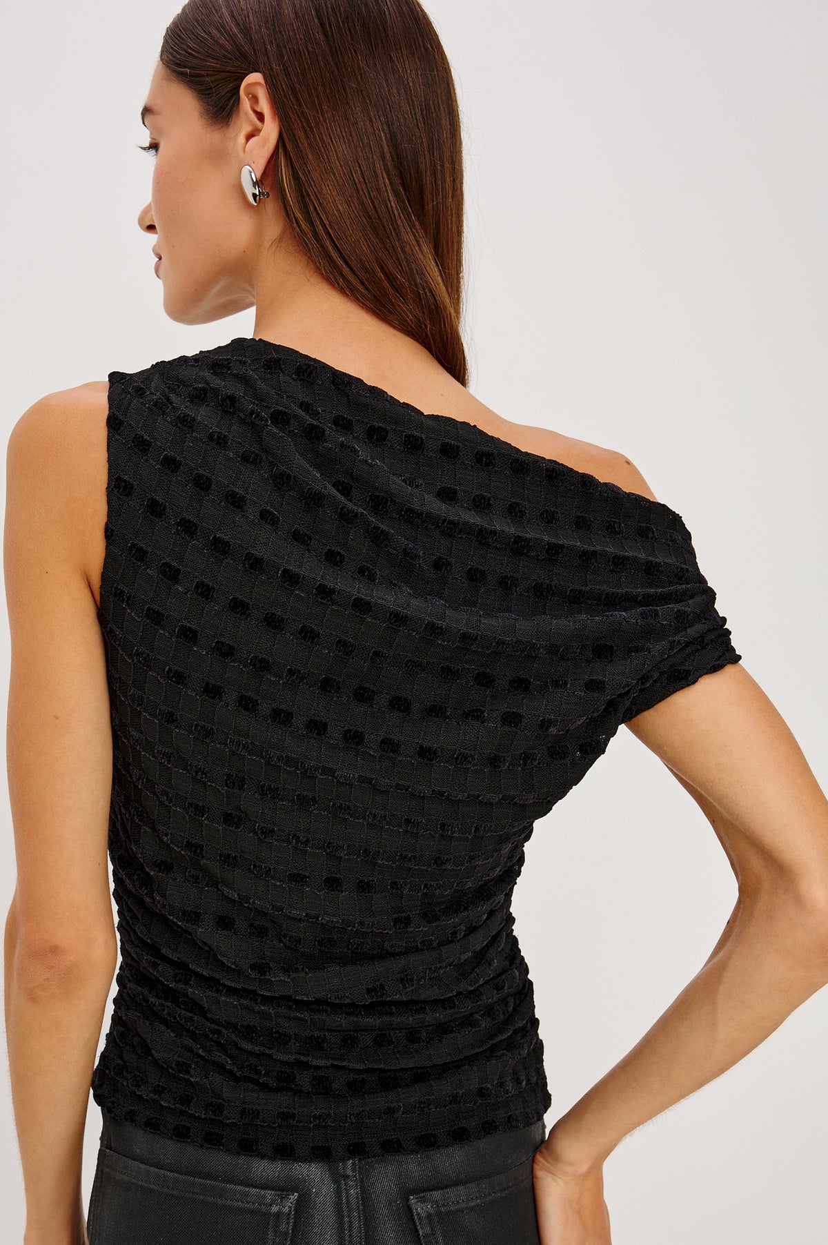 Dominic Top in Soft Jersey With Off-The-Shoulder One-Shoulder Design, Shirred Shoulders, and Ruched Waist in Black Checkerboard Colorway - Upper Body Back View Featured on Model.