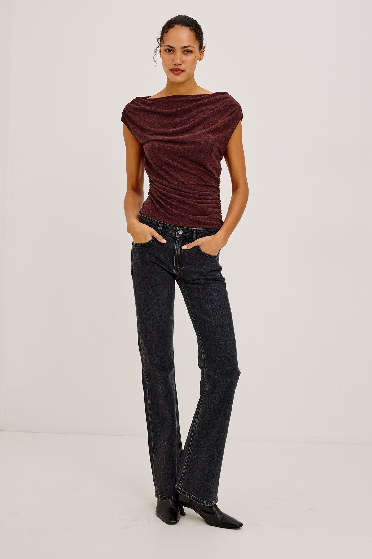 Dominic Top in Soft Jersey With Off-The-Shoulder One-Shoulder Design, Shirred Shoulders, and Ruched Waist in Merlot Colorway - Full Body Front View Featured on Model