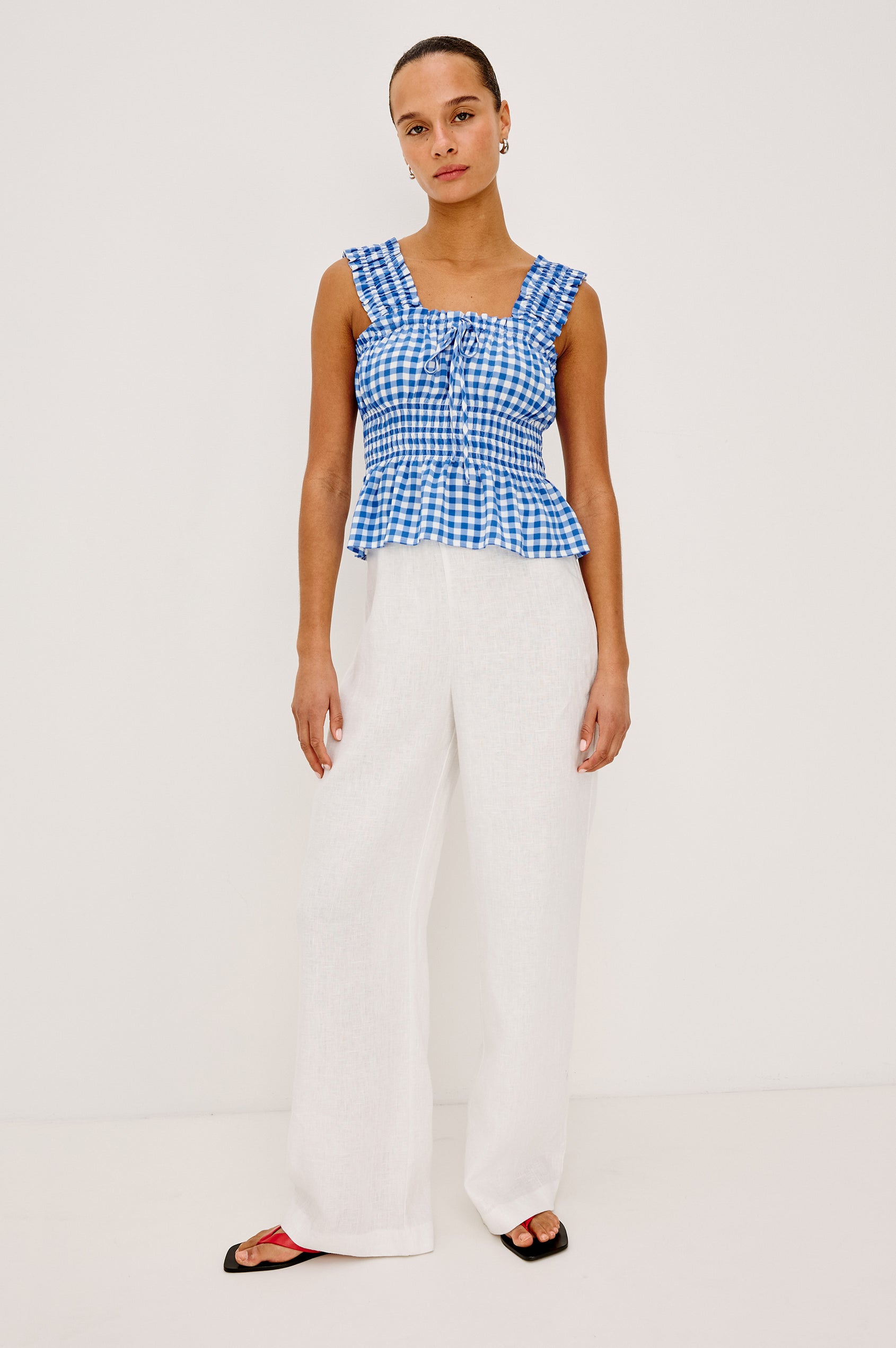 Donna Top With Square Neckline, Smocked Shouolder Straps, Center-Front Bust Ties, Smocked Waist, and Peplum Hem in Azure Gingham Colorway - Full Body Front View Featured on Model