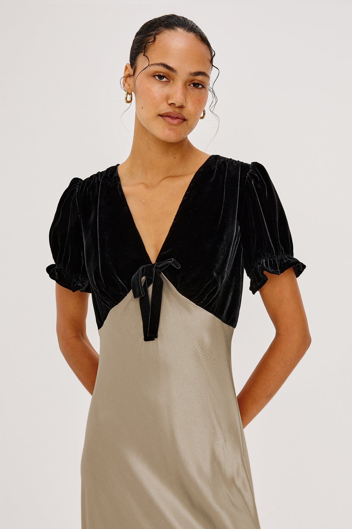 Dory Maxi Dress With V-Neckline and Adjustable Center Bust Ties, Short Puff Sleeves, Satin Back Crepe Skirt, and Back Zipper Closure in Mink Colorway - Front Crop Upper Body View Featured on Model.