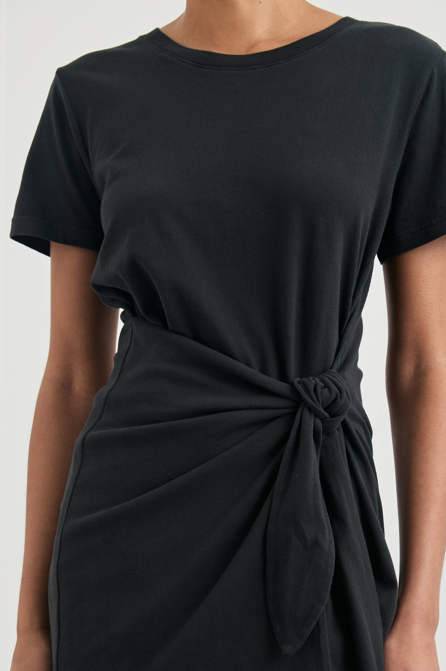 Edie Above-Knee Dress with Short Sleeves, Crew Neckline and Adjustable Wrap Tie At Waist in Vintage Black Colorway - Front View Featured on Model