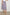 Edina Tiered Midi Skirt with Shirred High-Rise Waistline in Spring Floral Colorway, with mostly pinks and purples - Front View Featured on Model