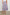 Edina Tiered Midi Skirt with Shirred High-Rise Waistline in Spring Floral Colorway, with mostly pinks and purples - Back View Featured on Model