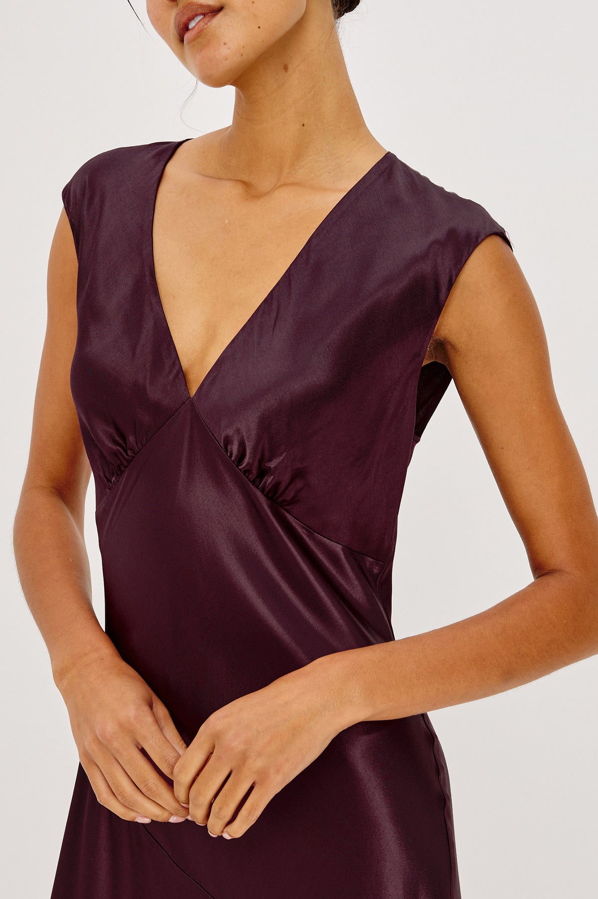 Eleni Midi Dress in Satin-Back Crepe With V-Neckline, Side Zip, Asymmetric Seam, and Handkerchief Hem in Wine Colorway - Front Crop Detail View Featured on Model.