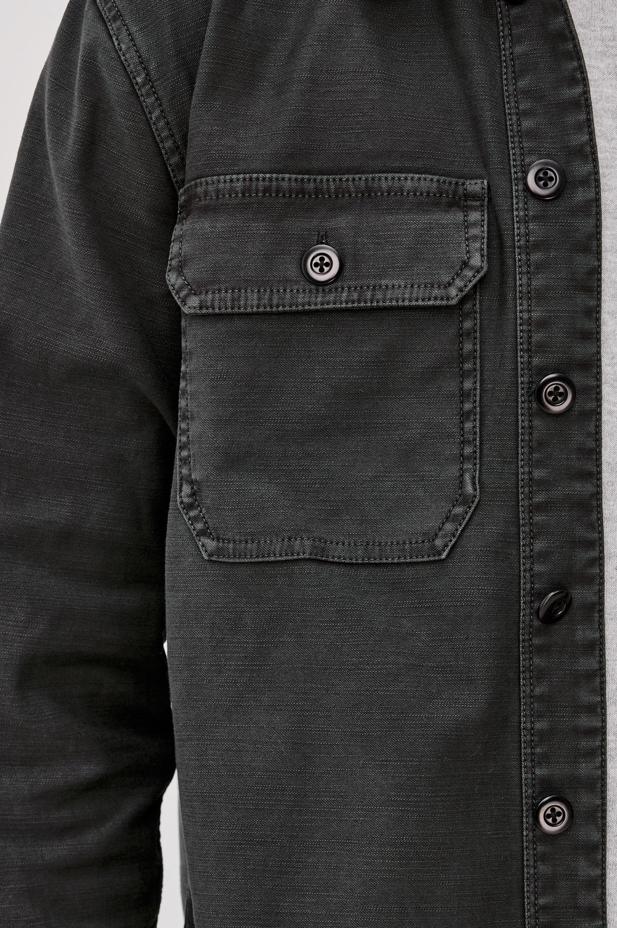 Eliot Shirt With Collar, Chest Buttoned Flap Pockets, Front Buttons, and Long Sleeves in Washed Black Colorway - Upper Body Front Close Up View Featured on Model