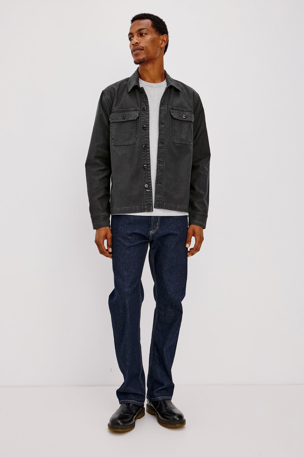Eliot Shirt With Collar, Chest Buttoned Flap Pockets, Front Buttons, and Long Sleeves in Washed Black Colorway - Full Body Front View Featured on Model