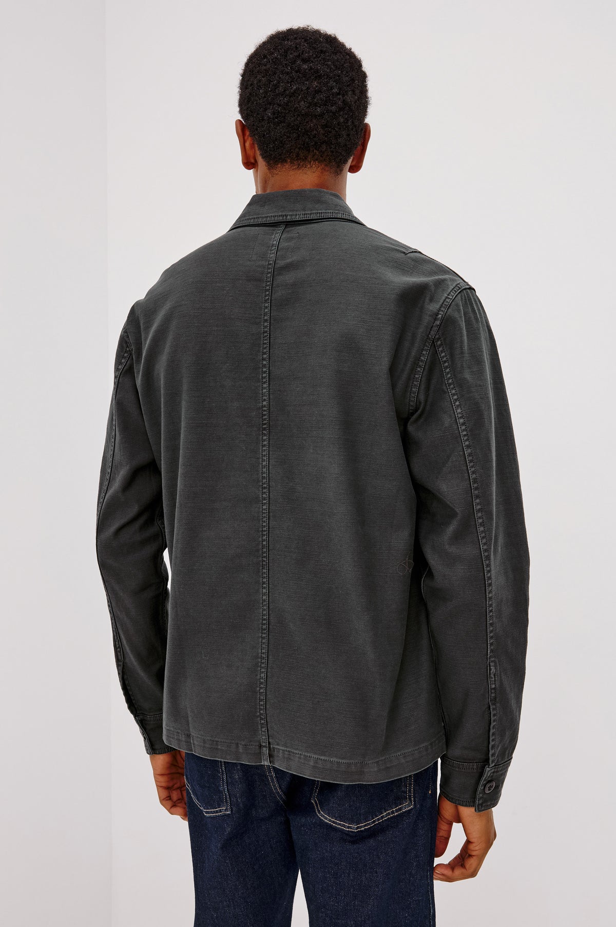 Eliot Shirt With Collar, Chest Buttoned Flap Pockets, Front Buttons, and Long Sleeves in Washed Black Colorway - Upper Body Back View Featured on Model