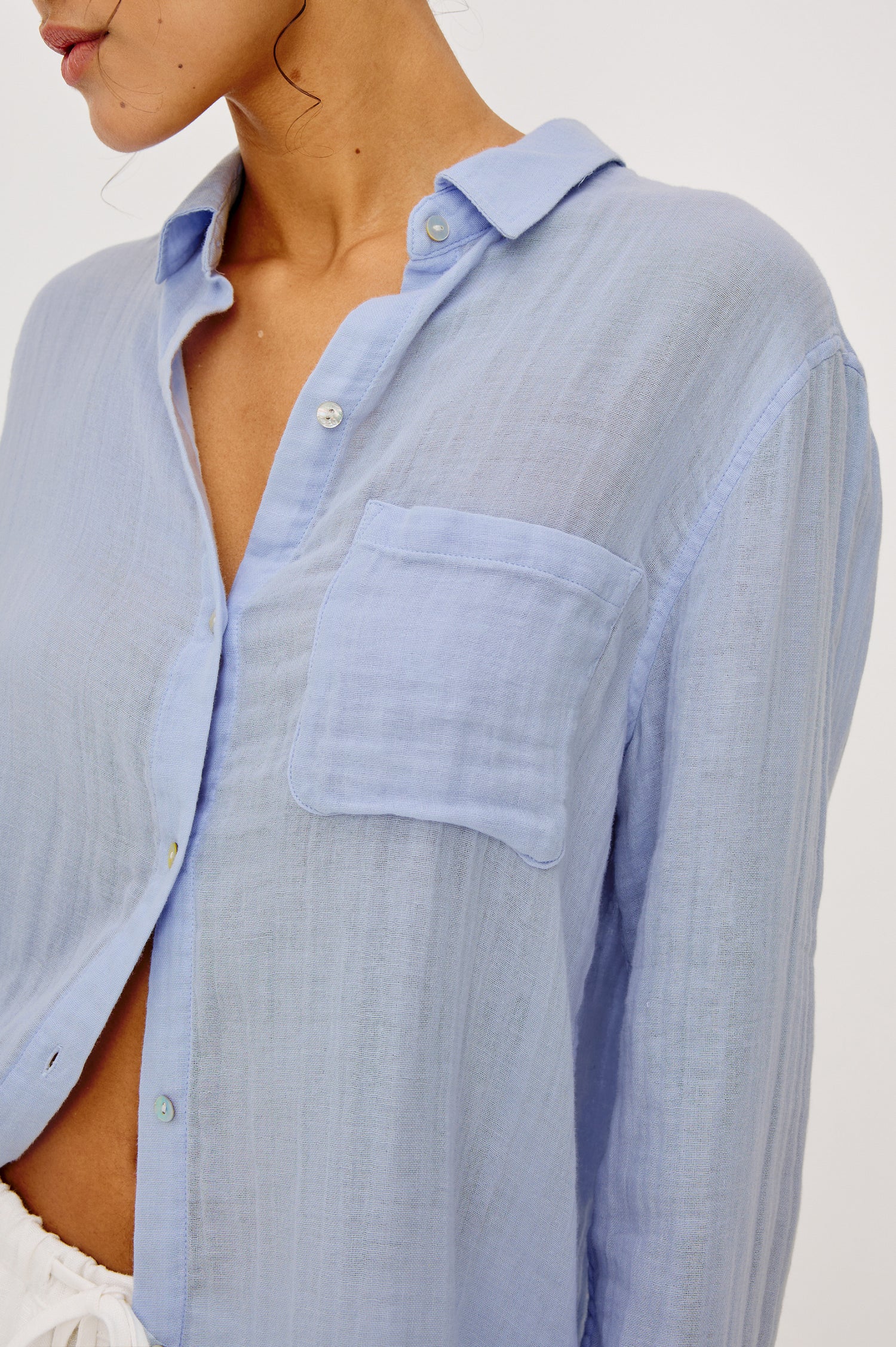 Ellis Relaxed Collared Button Front Shirt with Long Sleeves and a Chest Pocket in Baby Blue Colorway. Upper Body Front View Zooomed In Details Shown on Model.