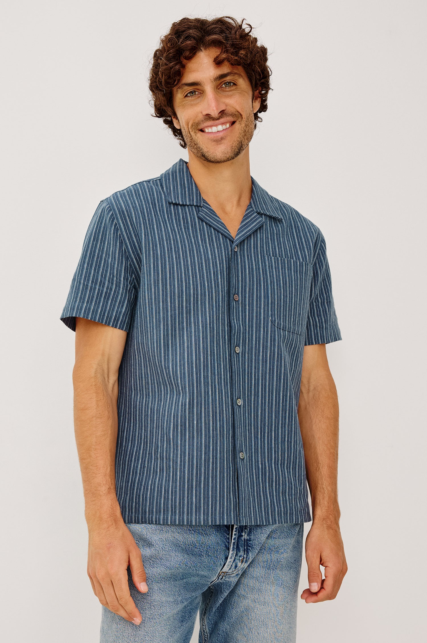 Ely Camp Shirt in Homespun Weave With Collar, Short Sleeves, Front Buttons, and Slightly-Boxy Fit in Navy Multi Stripe Colorway - Upper Body Front View Featured on Model