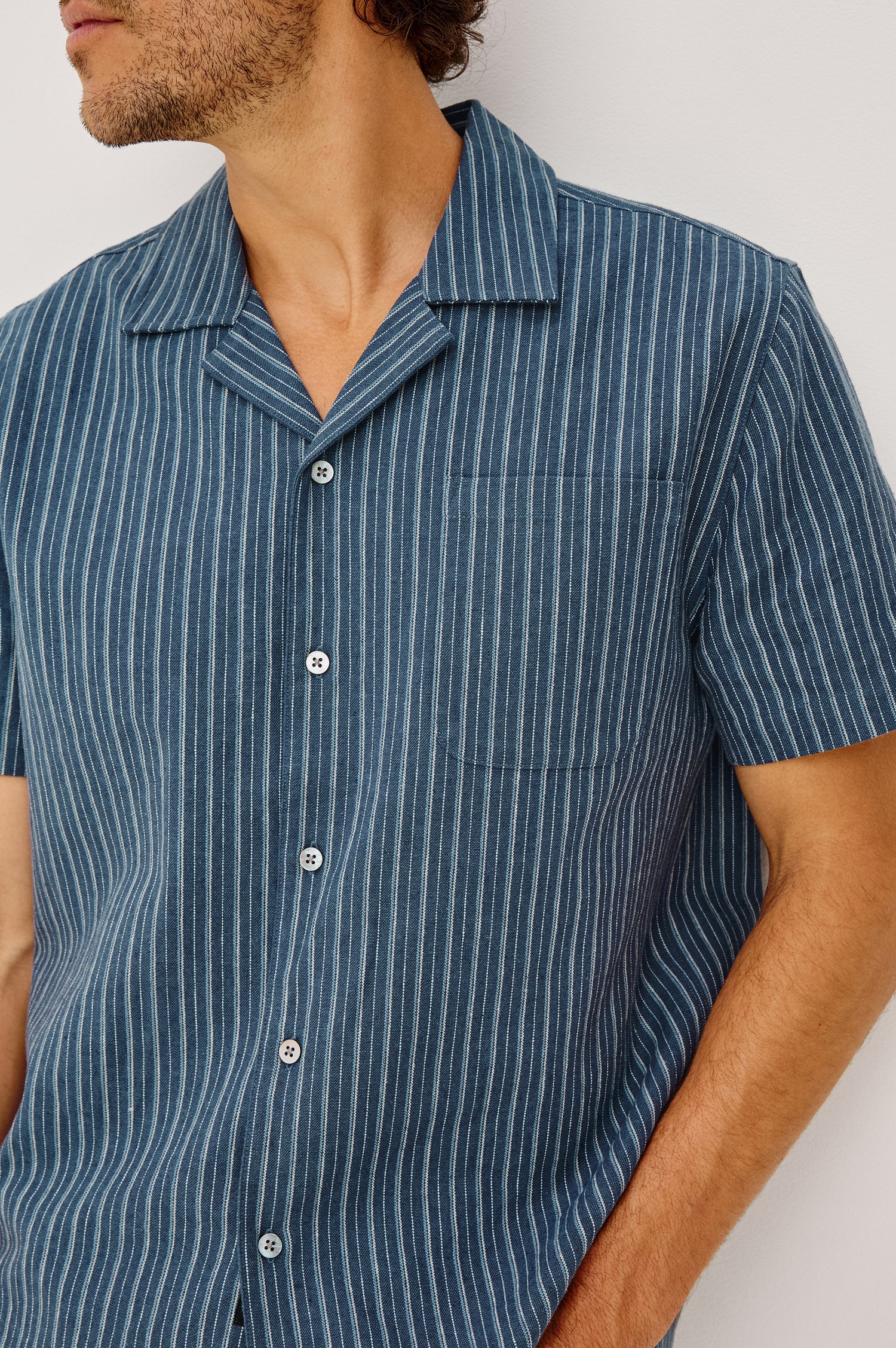 Ely Camp Shirt in Homespun Weave With Collar, Short Sleeves, Front Buttons, and Slightly-Boxy Fit in Navy Multi Stripe Colorway - Upper Body Front View Featured on Model