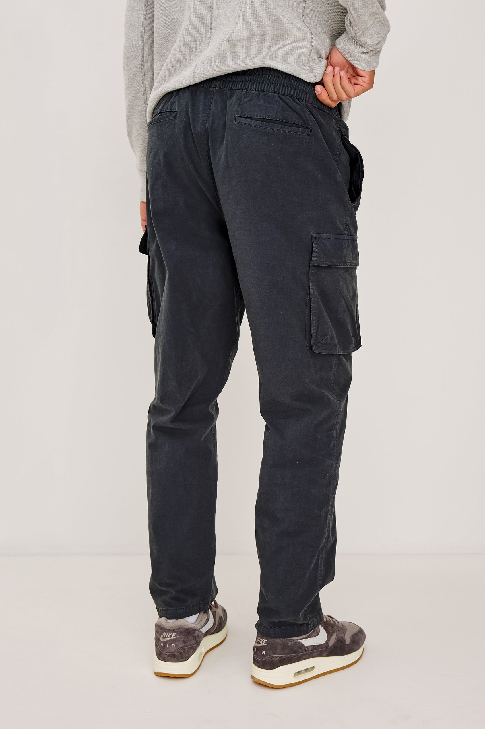 Emmerson Pant in Lightweight Cotton With Cargo Pockets and Drawstring Waist in Washed Black Colorway - Lower Body Back View Featured on Model