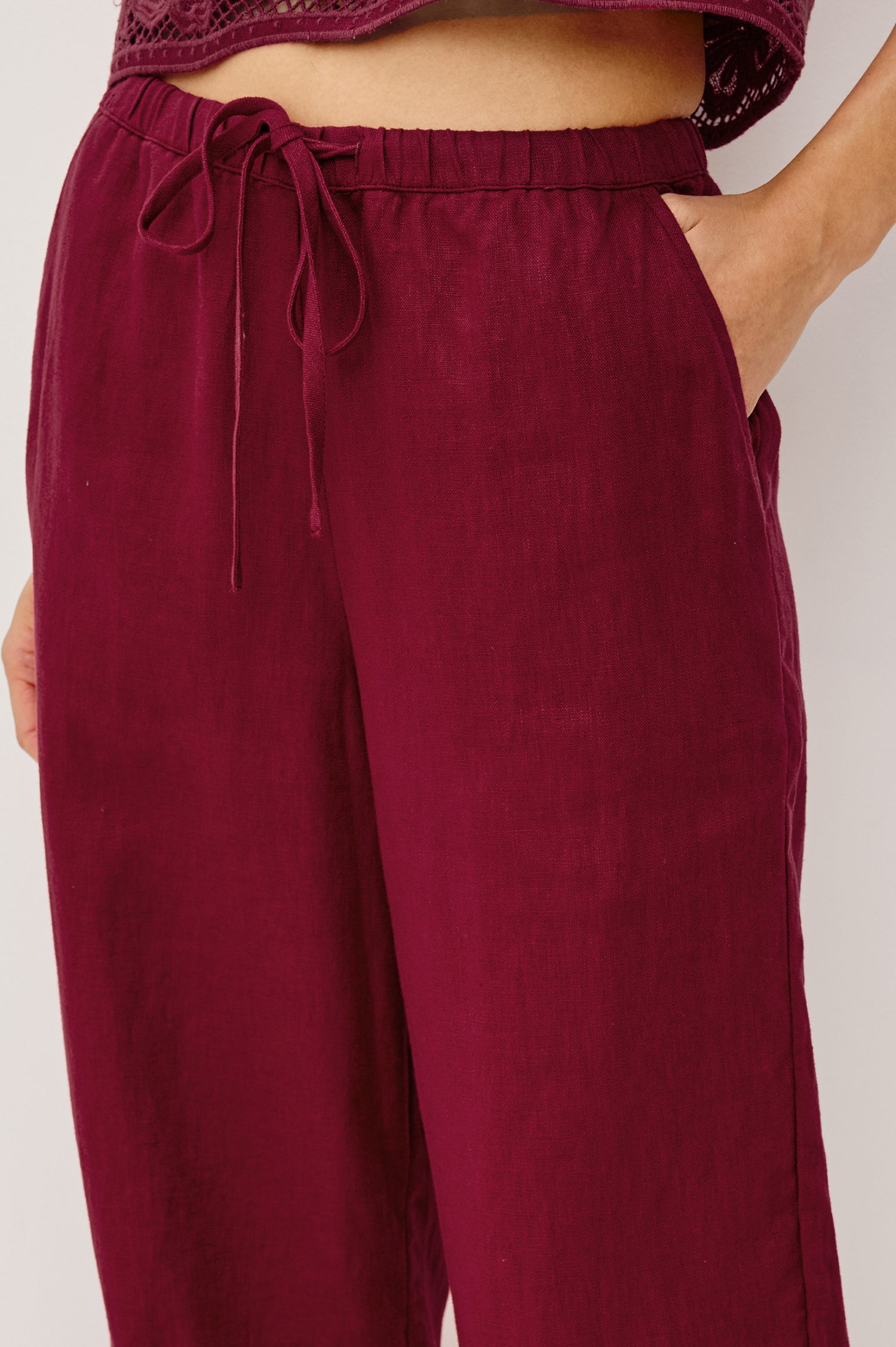 Emmie Straight Leg Pant in Linen With Adjustable Drawstring Waist Ties in Hibiscus Embroidery Colorway — Lower Body Front View Featured on Model