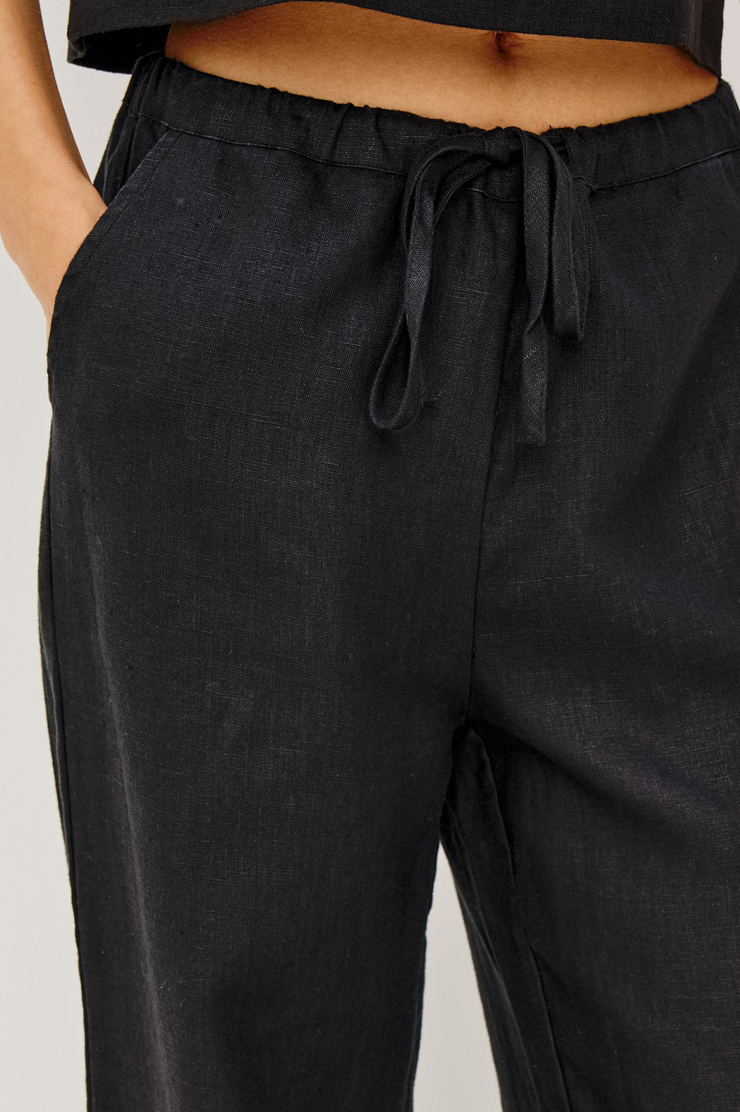 Emmie high rise linen wide leg pant with drawstring in black - front view on model