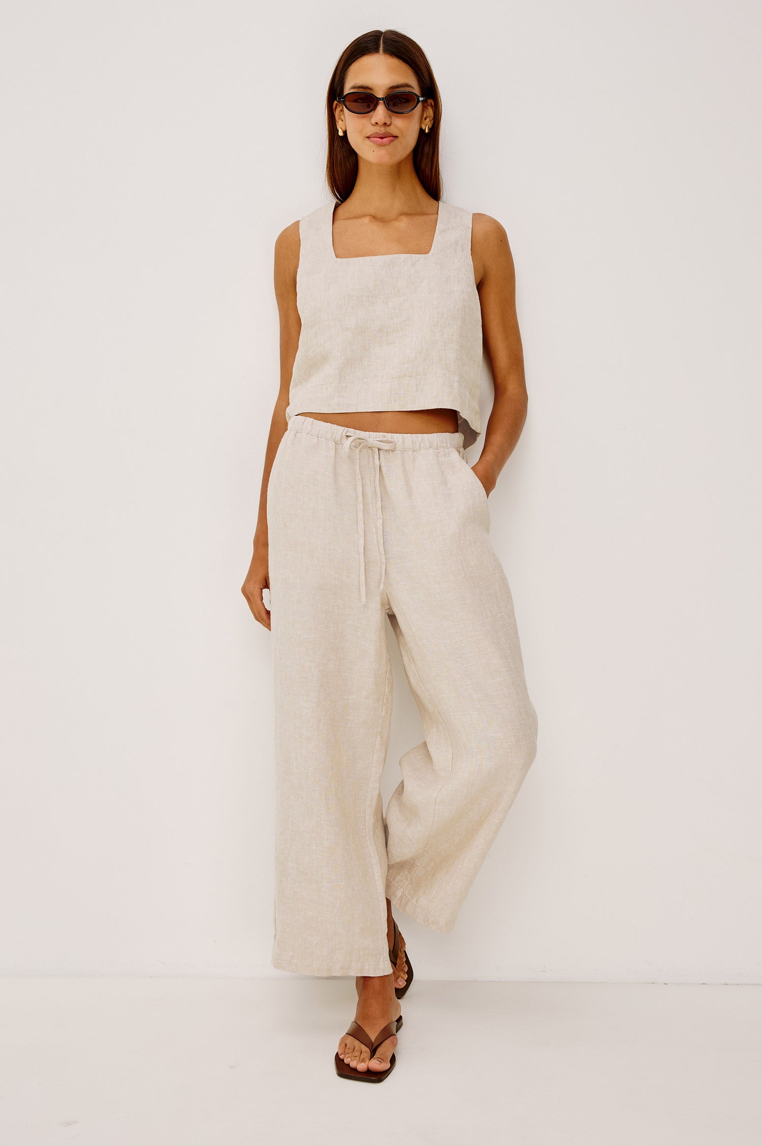 Emmie Crop Pant in Linen With Straight Legs, Adjustable Drawstring Waist Ties, and Side Pockets in Heathered Flax Colorway - Full Body Front View Featured on Model