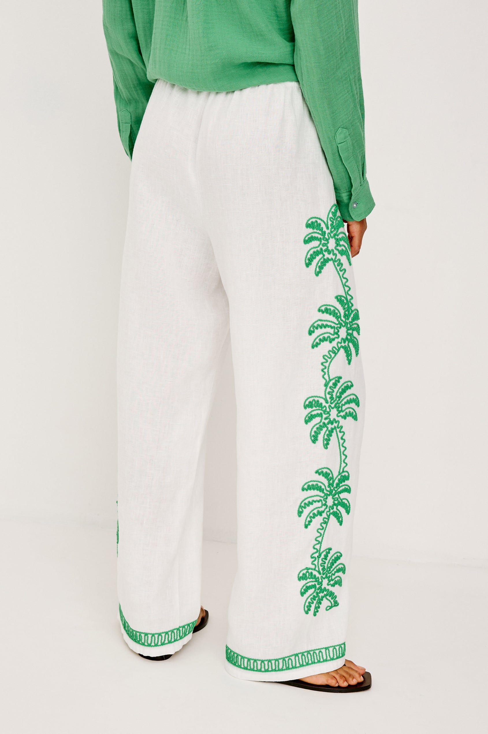 Emmie Straight Leg Pant in Unlined Linen With Adjustable Drawstring Waist Ties and Side Pockets in Emerald Palms Embroidery Colorway — Lower Body Back View Featured on Model
