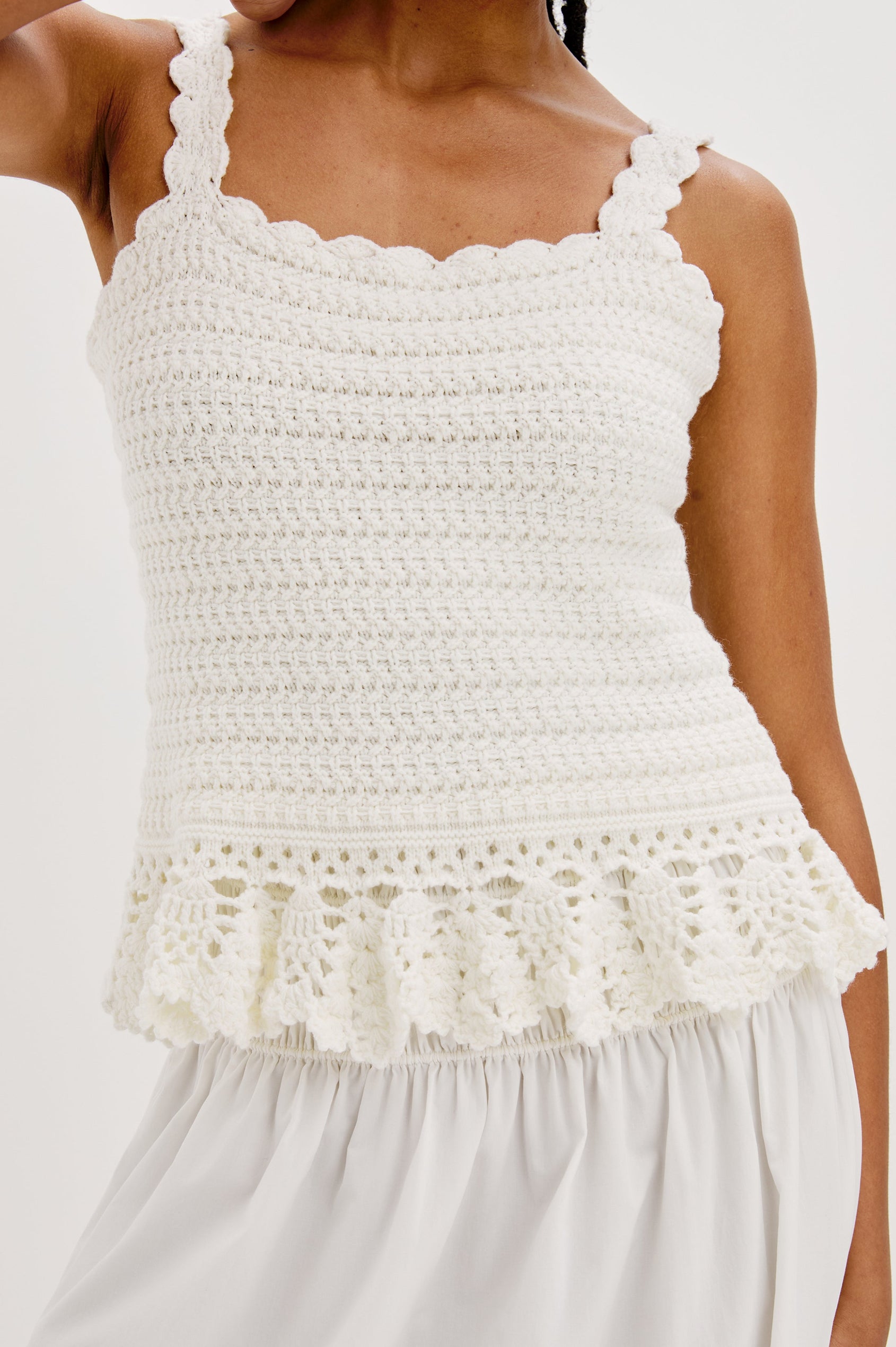 Estefania Tank Top with Scalloped Straps and a Small Peplum Embroidered Ruffle Hem in White Colorway. Front Detailed View Shown on Model.