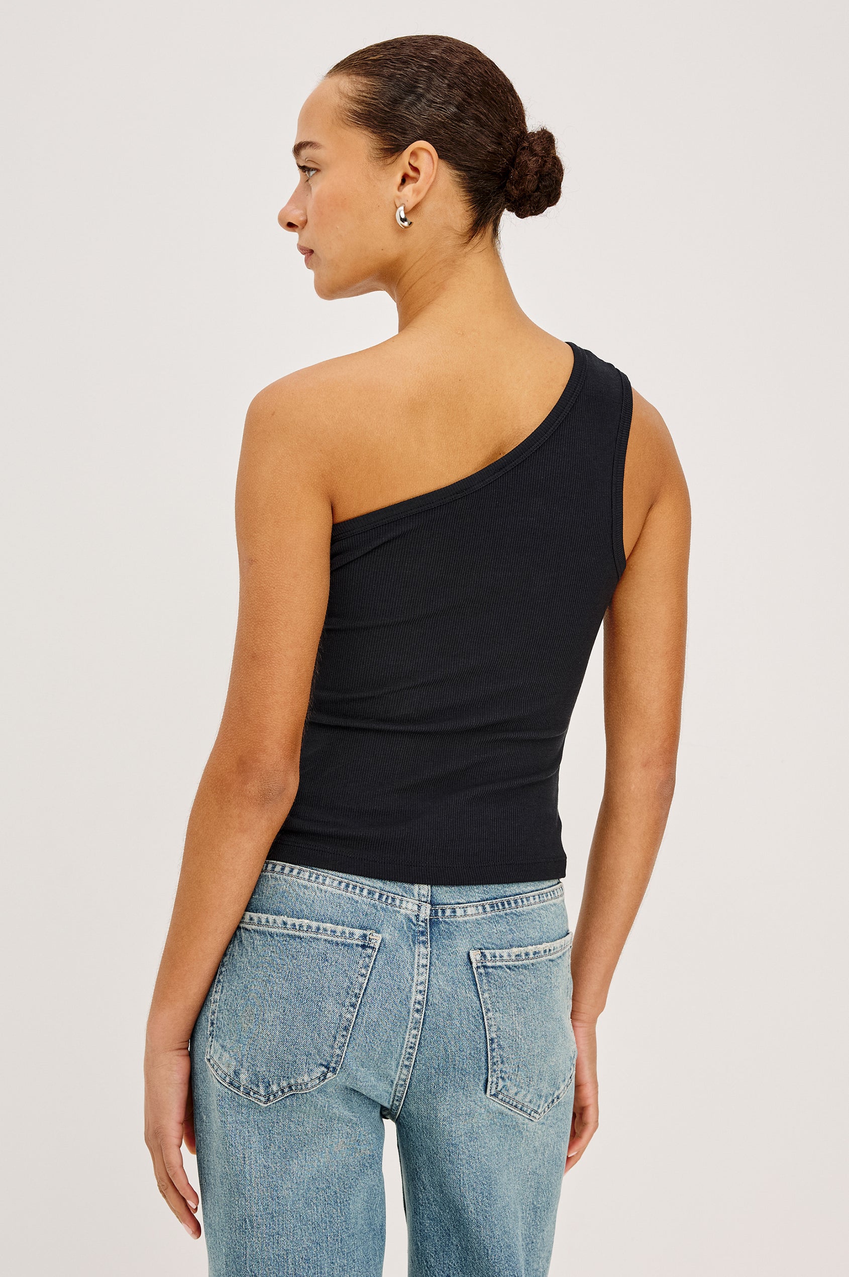 Esti Tank Top in Ribbed Cotton Blend With One-Shoulder Neckline in Black Colorway - Upper Body Back View Featured on Model