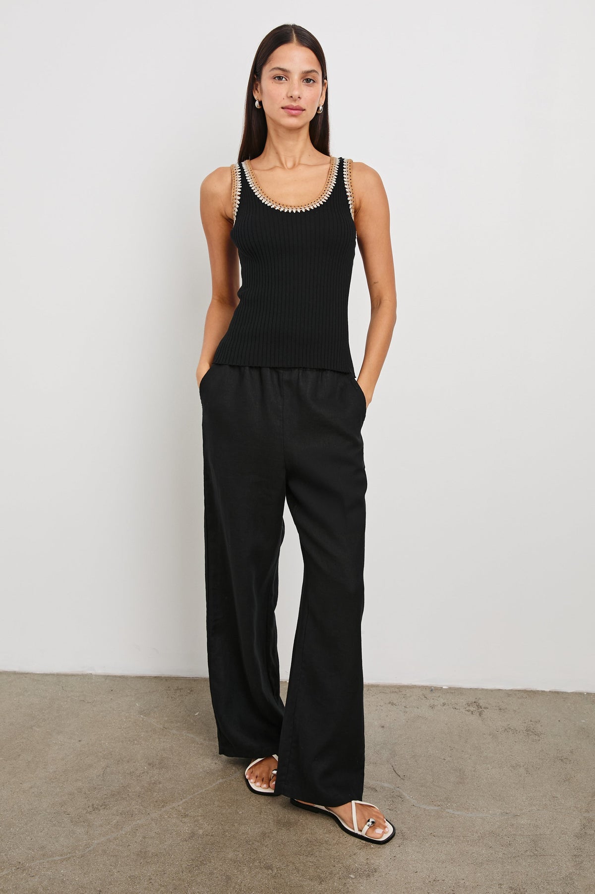 Estrella Ribbed Cami with a Scoop Neck and Crochet Trim Along the Straps and Neckline in Black Colorway with White, Beige, and Tan Trim - Front Full Body View Featured on Model