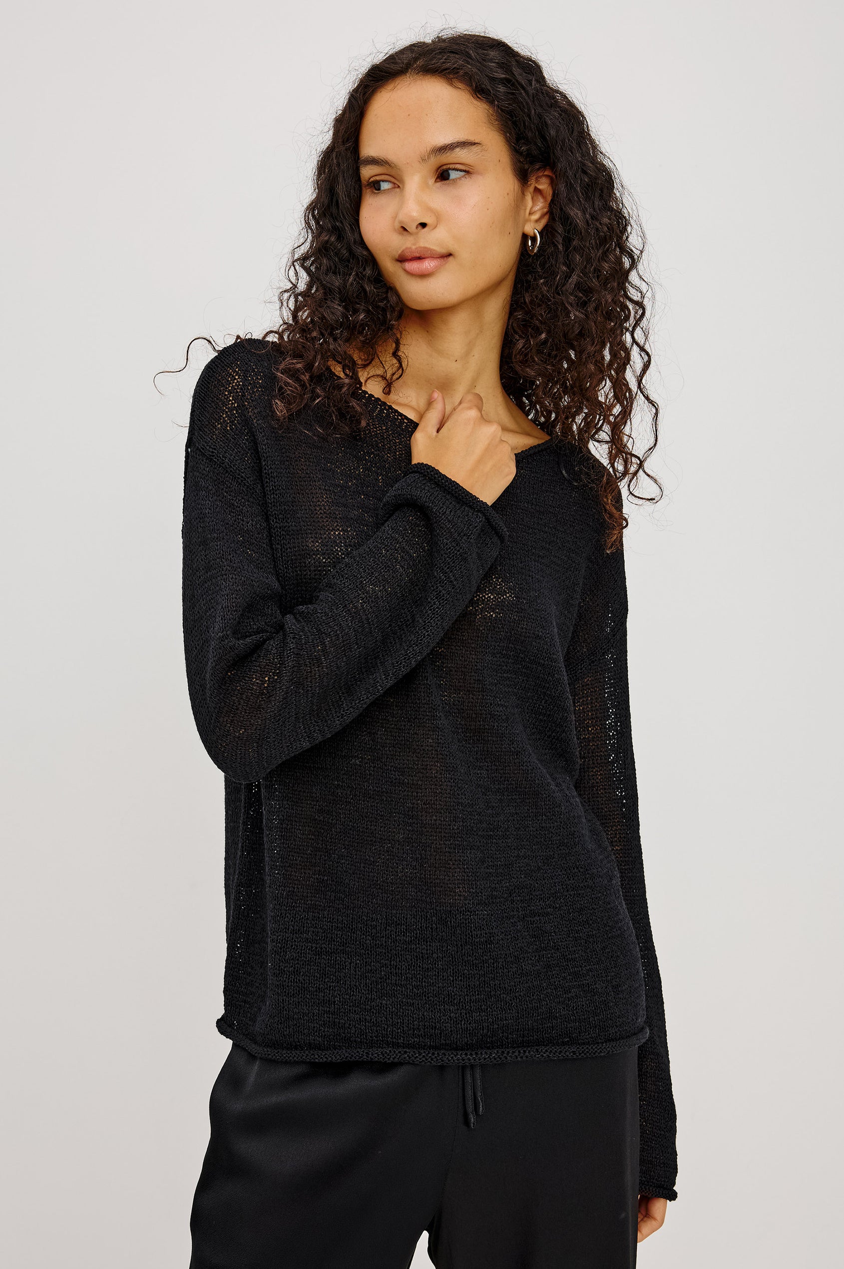 Evangeline Sweater in Luxe Linen Blend With Open Weave, Boat Neck, Relaxed Dropped Shoulders, and Long Sleeves in Black Colorway - Upper Body Front View Featured on Model