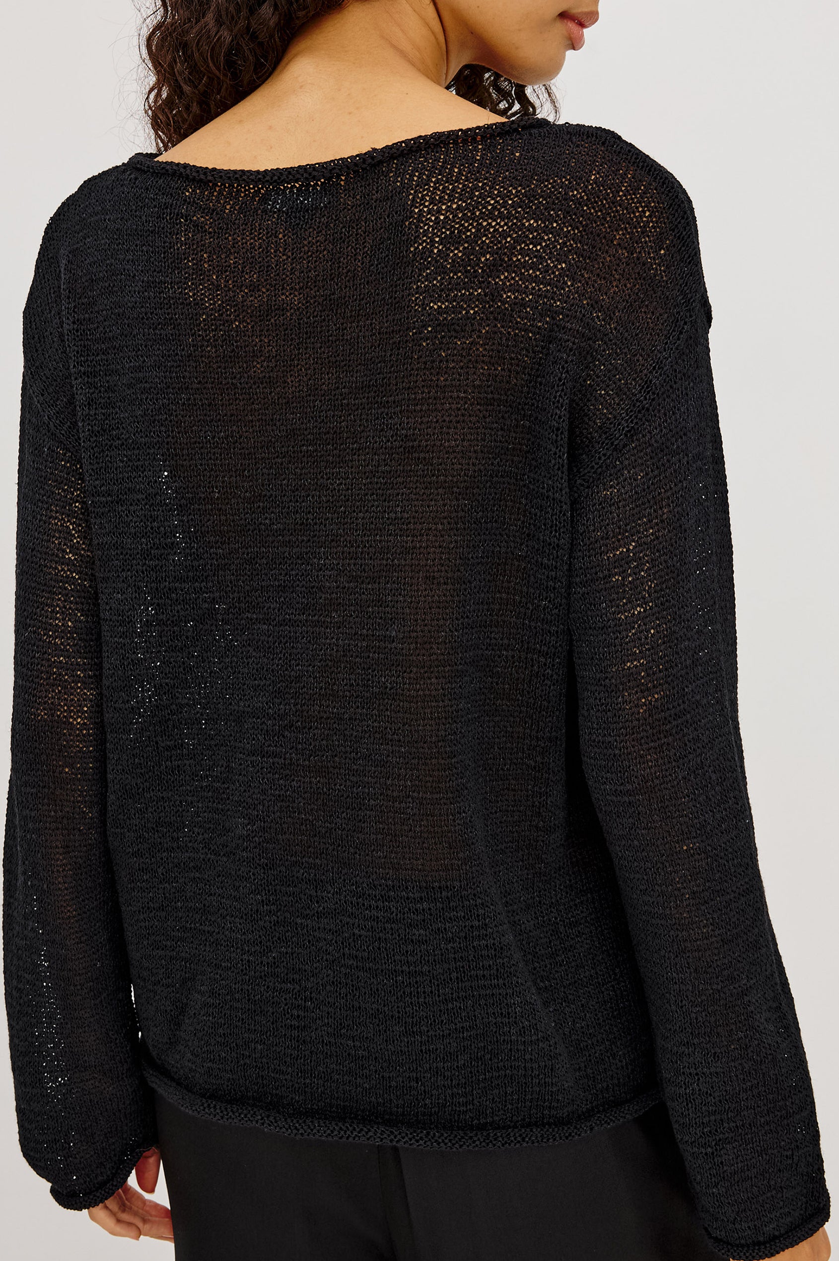 Evangeline Sweater in Luxe Linen Blend With Open Weave, Boat Neck, Relaxed Dropped Shoulders, and Long Sleeves in Black Colorway - Upper Body Back View Featured on Model