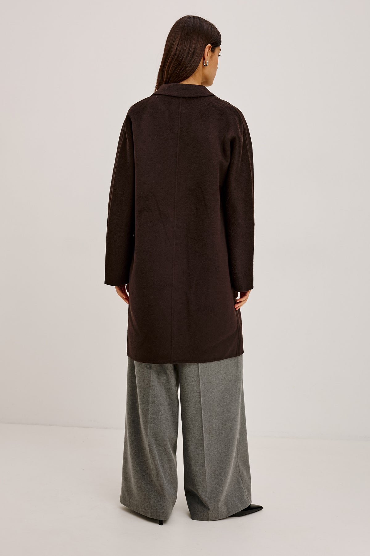 Everest Coat in Heavy Wool Blend With Longline Cut, Slightly Oversized Relaxed Fit, Lapel Collar, Single-Button Front, and Front Patch Pockets in Chocolate Colorway - Upper Body Back View Featured on Model.