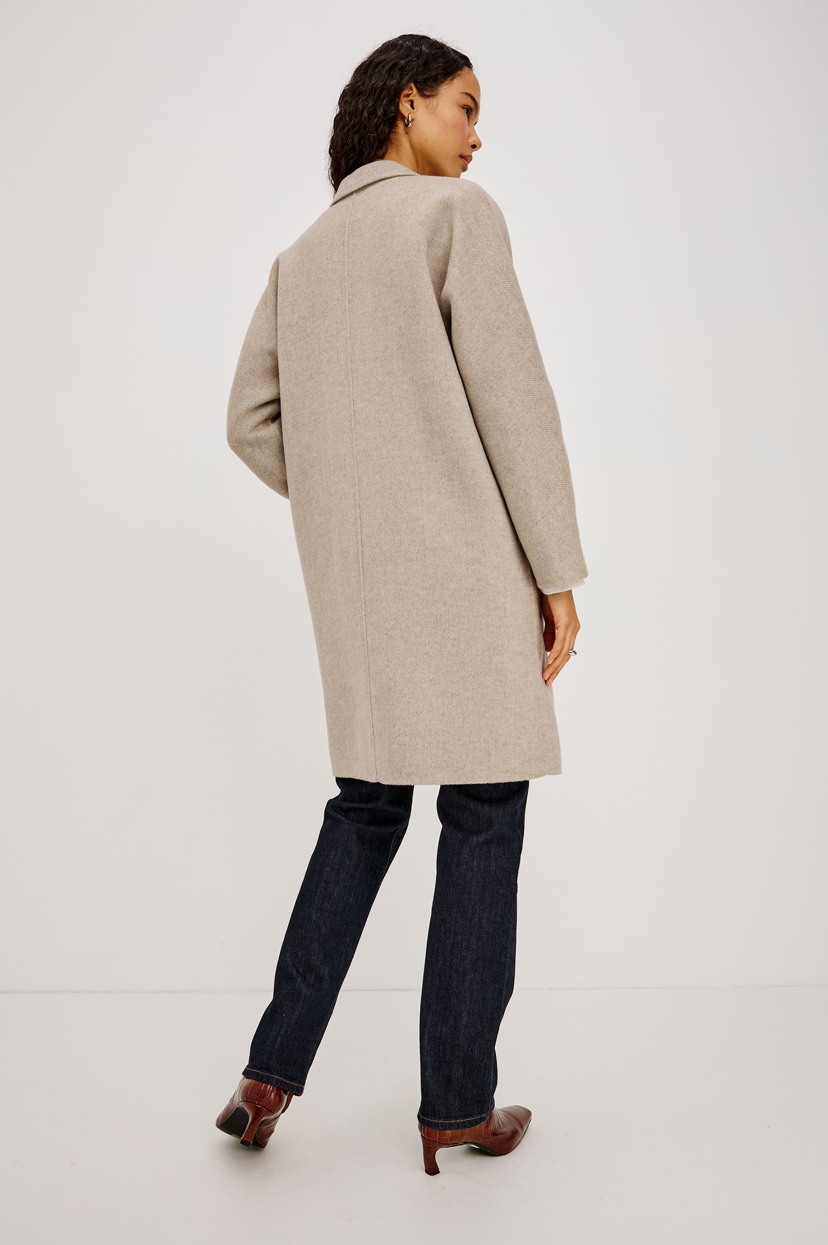 Everest Coat in Heavy Wool Blend With Longline Cut, Slightly Oversized Relaxed Fit, Lapel Collar, Single-Button Front, and Front Patch Pockets in Oat Herringbone Colorway - Full Body Back View Featured on Model