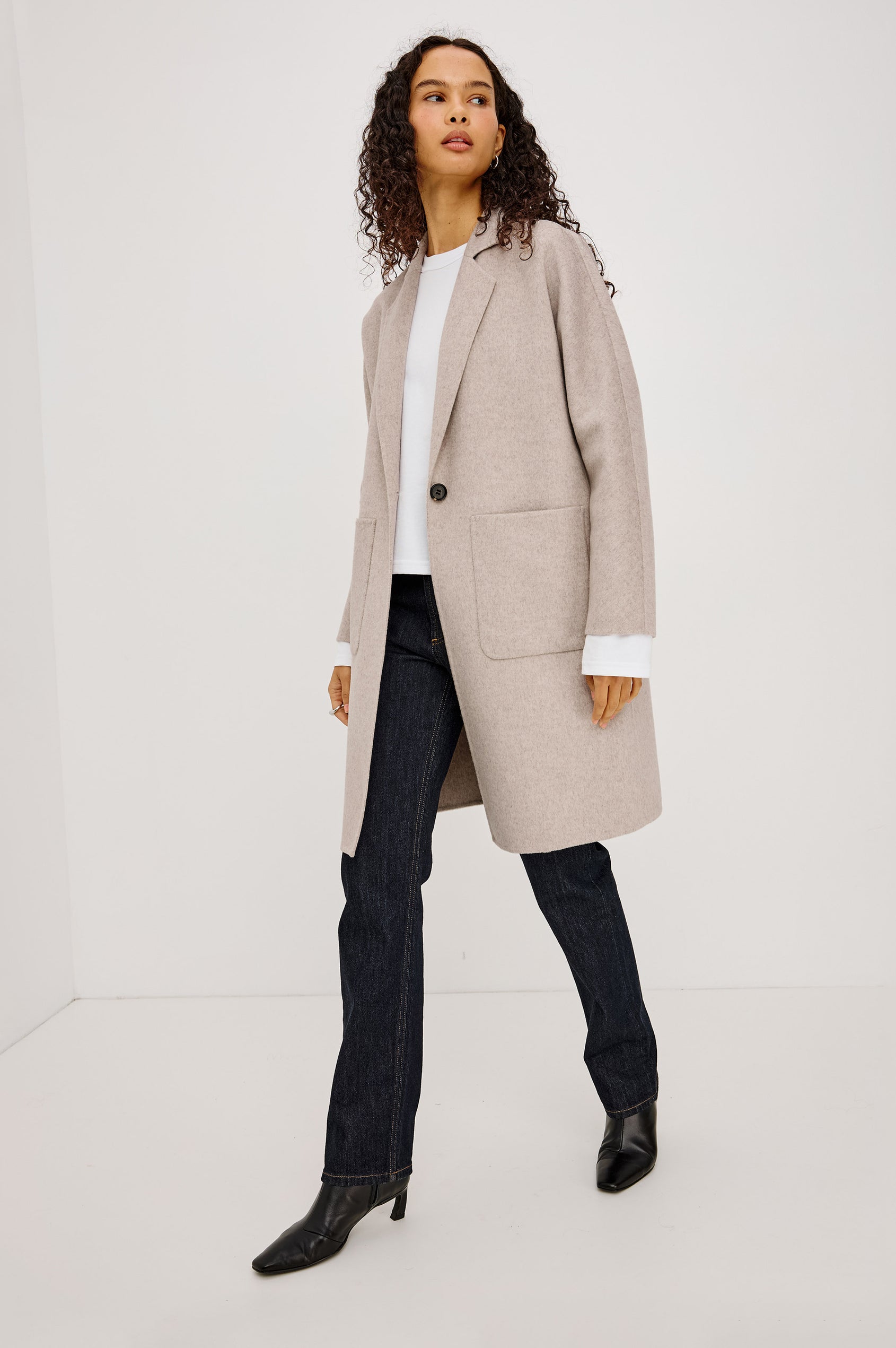 Everest Coat in Heavy Wool Blend With Longline Cut, Slightly Oversized Relaxed Fit, Lapel Collar, Single-Button Front, and Front Patch Pockets in Oatmeal Colorway - Full Body Front View Featured on Model