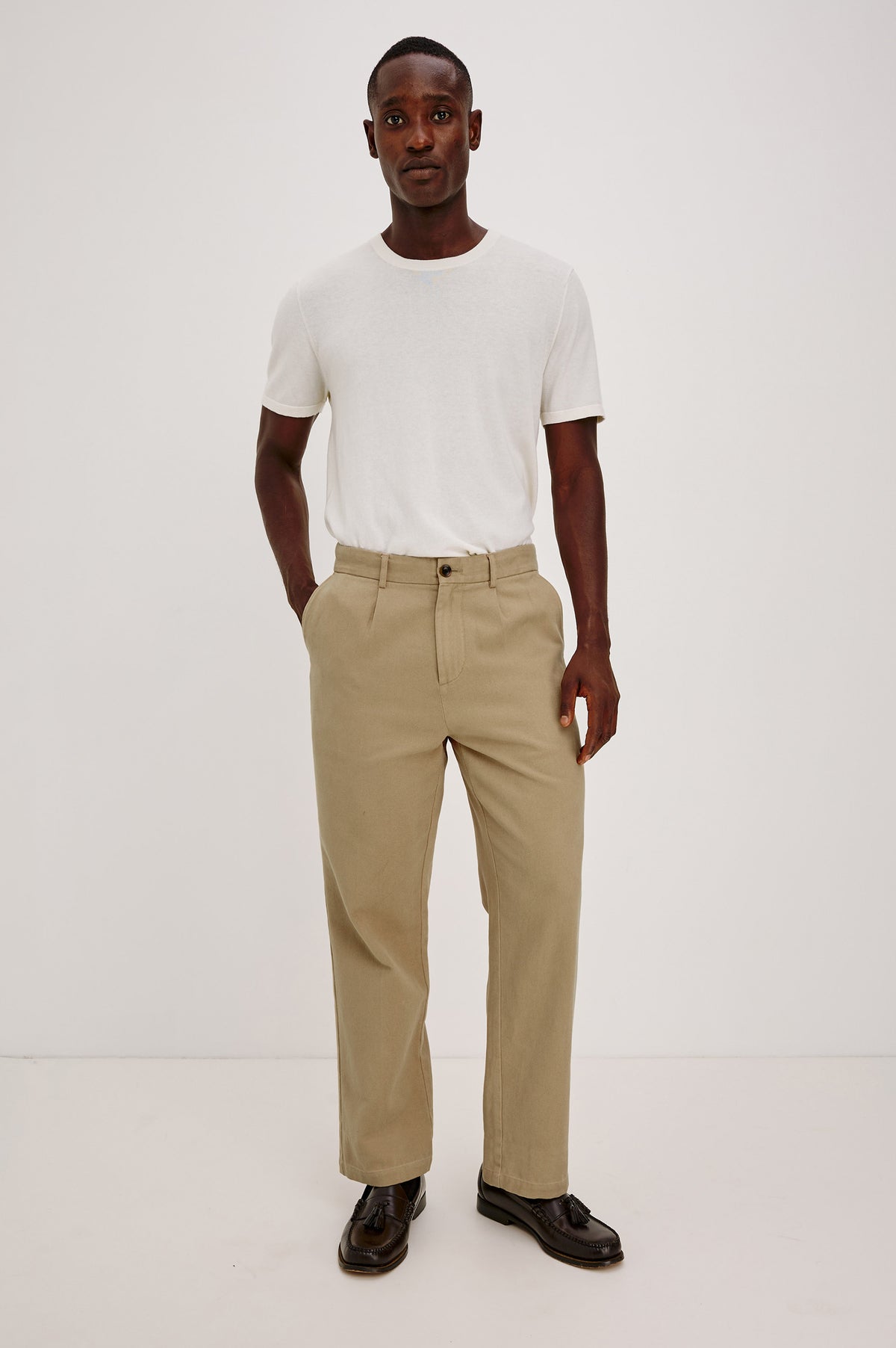 Ezra Pant in Brushed Cotton Twill With Relaxed Fit, Single Front Pleats, Ankle-Length Hem, Zip Fly, Side Pockets, and Back Double-Welt Pockets in British Khaki Colorway - Full Body Front View Featured on Model