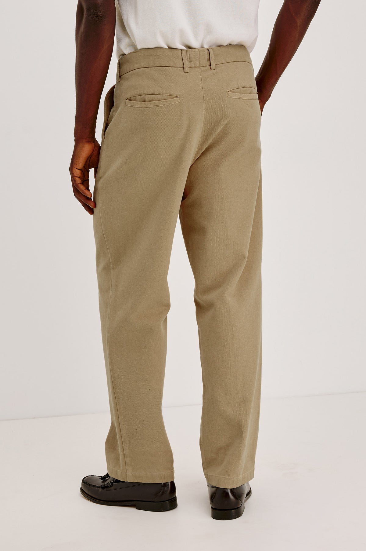 Ezra Pant in Brushed Cotton Twill With Relaxed Fit, Single Front Pleats, Ankle-Length Hem, Zip Fly, Side Pockets, and Back Double-Welt Pockets in British Khaki Colorway - Lower Body Back View Featured on Model