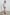 Fable Long Sleeve Top with a V Neck with a Placket, Buttoned Cuffs, and Pleating Down From the Yoke in Light Vintage Colorway, a Blue - Front Full Body View Featured on Model 