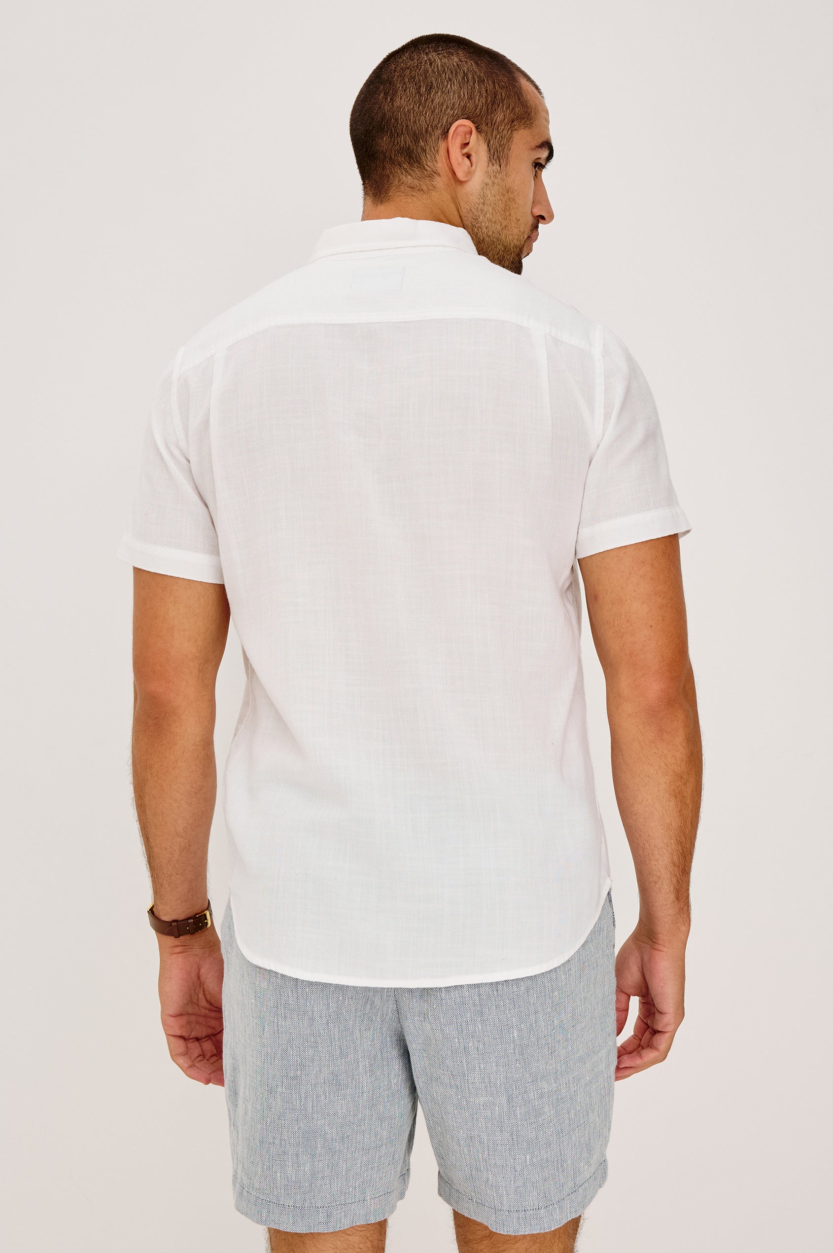 Fairfax Short Sleeve Button-Up Shirt in Lightweight Cotton With a Classic Fit in White Colorway - Upper Body Back View Featured on Model