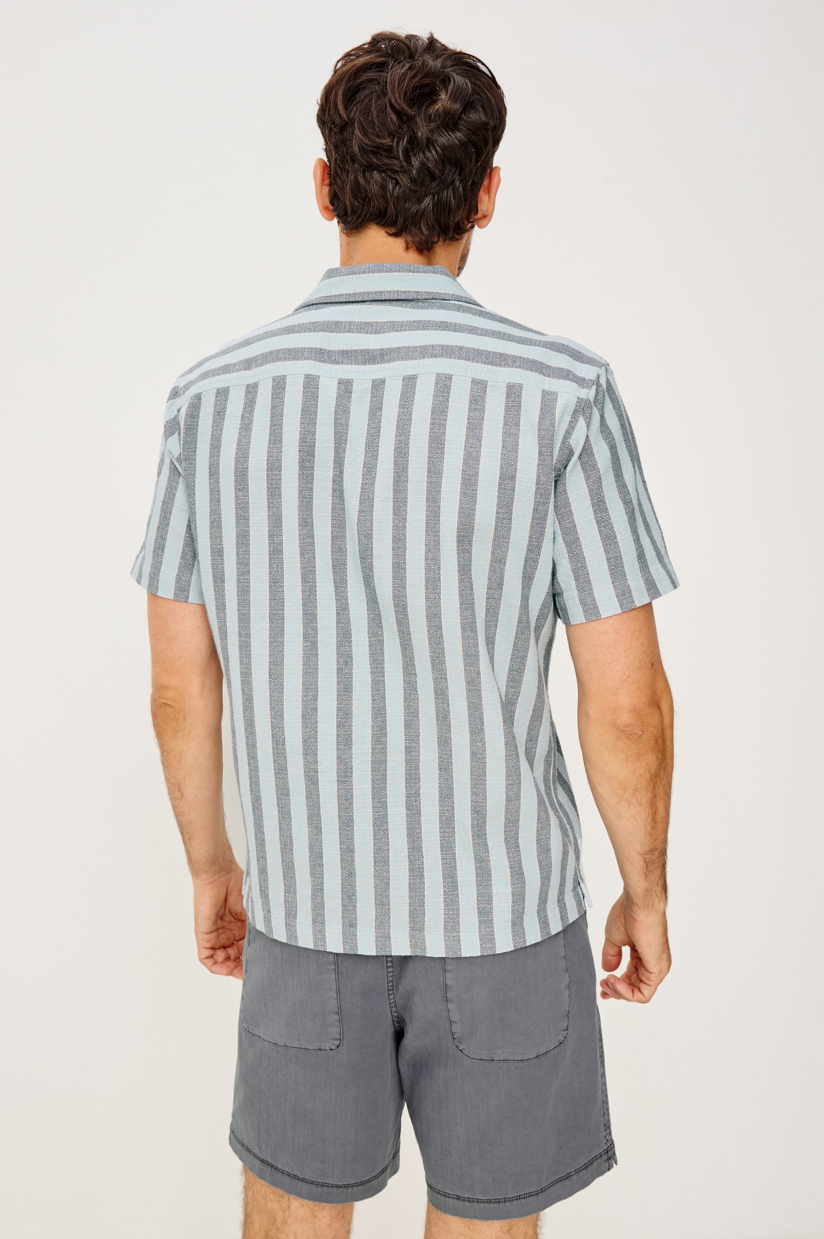 Fielder Camp Shirt With Front Buttons, Short Sleeves, and Relaxed, Boxy Fit in Blue Jay Stripe Colorway - Upper Body Back View Featured on Model