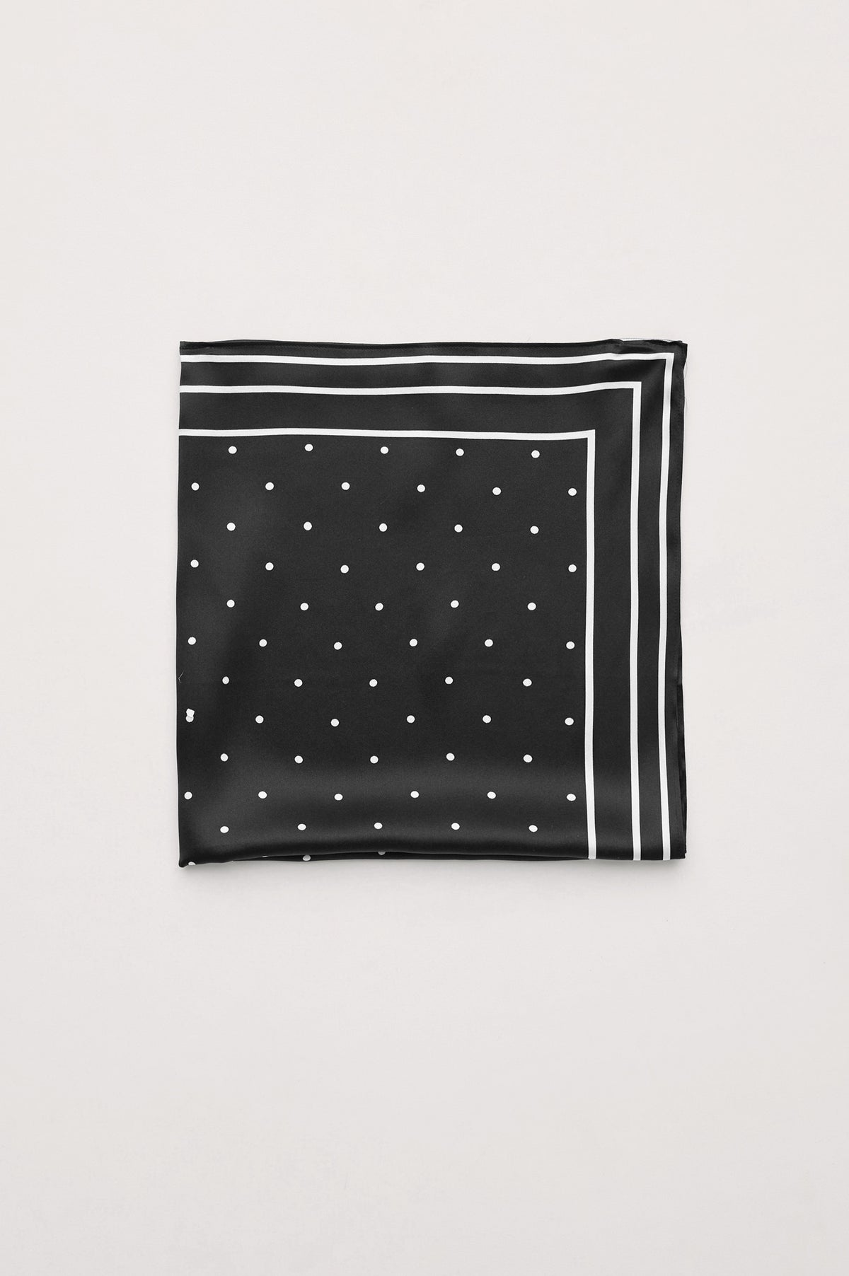 Finna Square Scarf in 100% Silk With Contrast Polka Dots and Striped Outline in Black Colorway - Folded Flat Lay View Featured