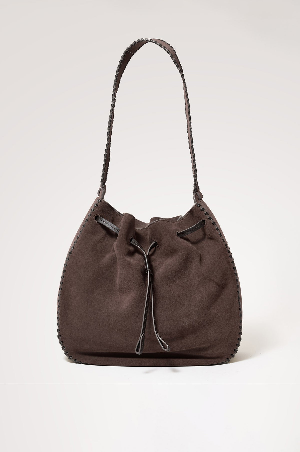 Firenze Bucket Bag in Suede With Whipstitch Trim, Drawcord Closure, and Interior Zip Pocket in Dark Brown Suede Colorway - front view of bag with strap extended.