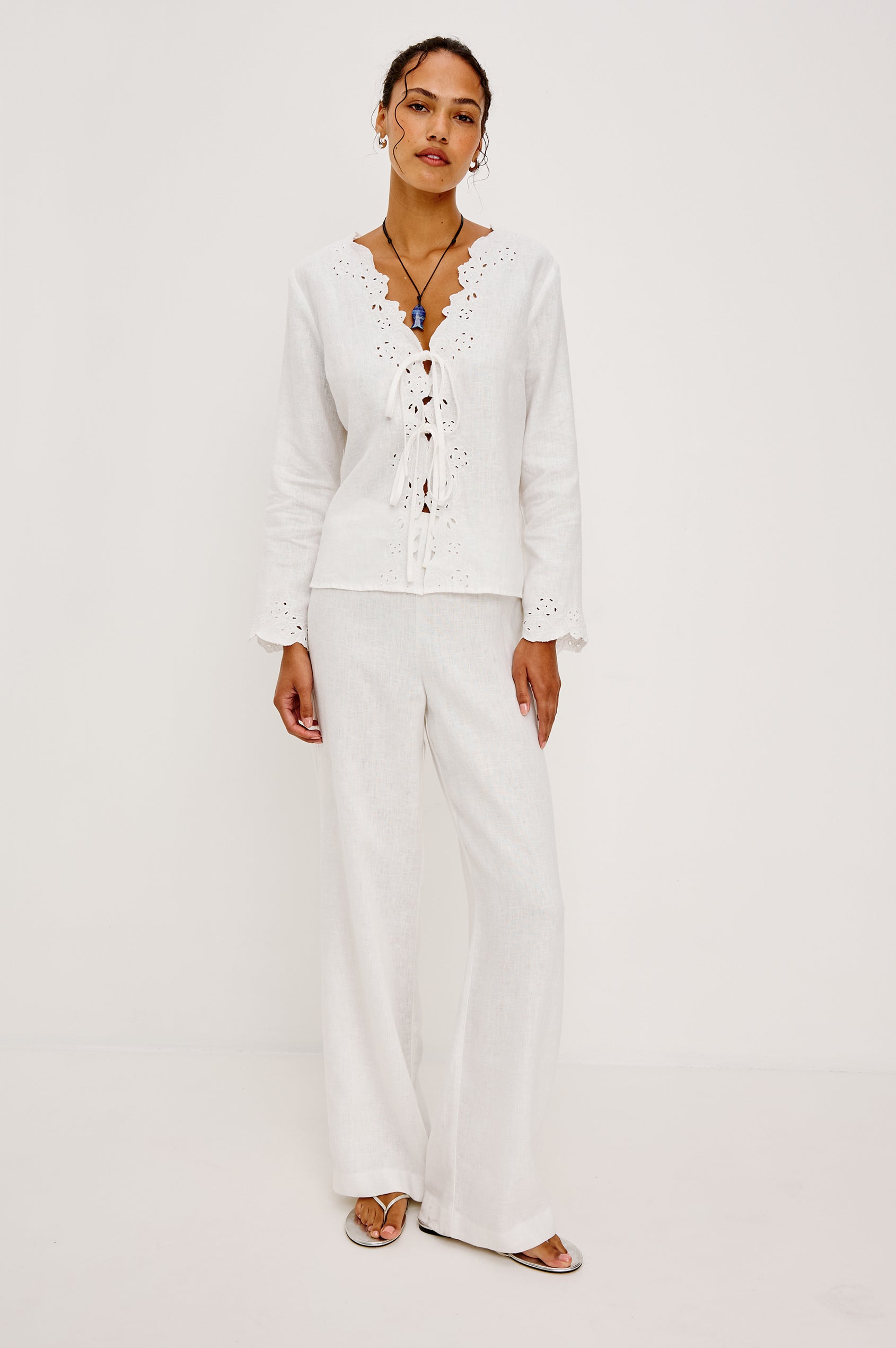 Fleur Top in Linen With Floral Eyelet Embroidery Open Front Adjustable Front Self-Ties Long Sleeves and Loose Fit in White - Full Body Front View Featured on Model
