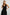 Franca Sleeveless Midi Dress with Twisted Shoulder Straps, a deep V Neck and Pleats at the Waist in Black Colorway - Front View Featured on Model