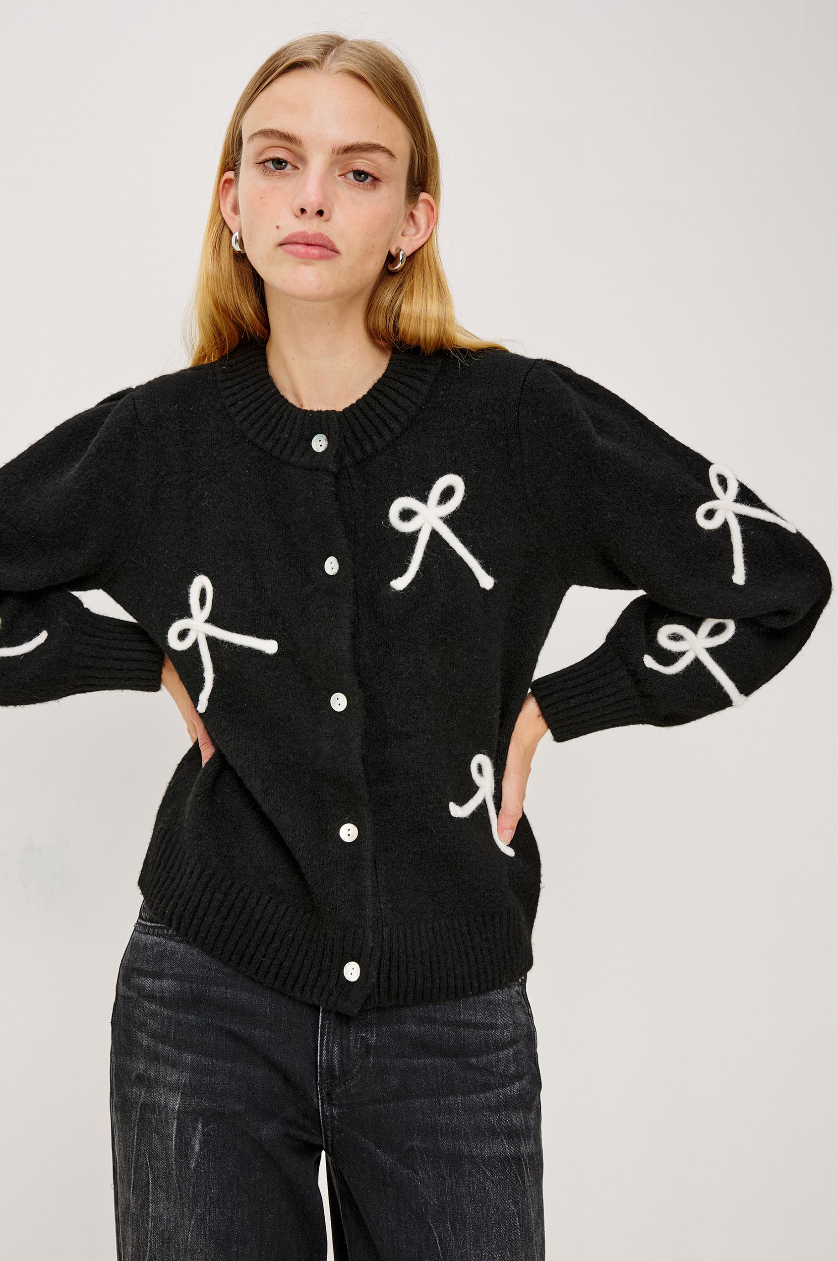 Francesca Long-Sleeve Cardigan with a Button Closure, Crew Neck, Ribbed Trim and Soutache Bow Appliques in Black Ivory Colorway - Front View Featured on Model