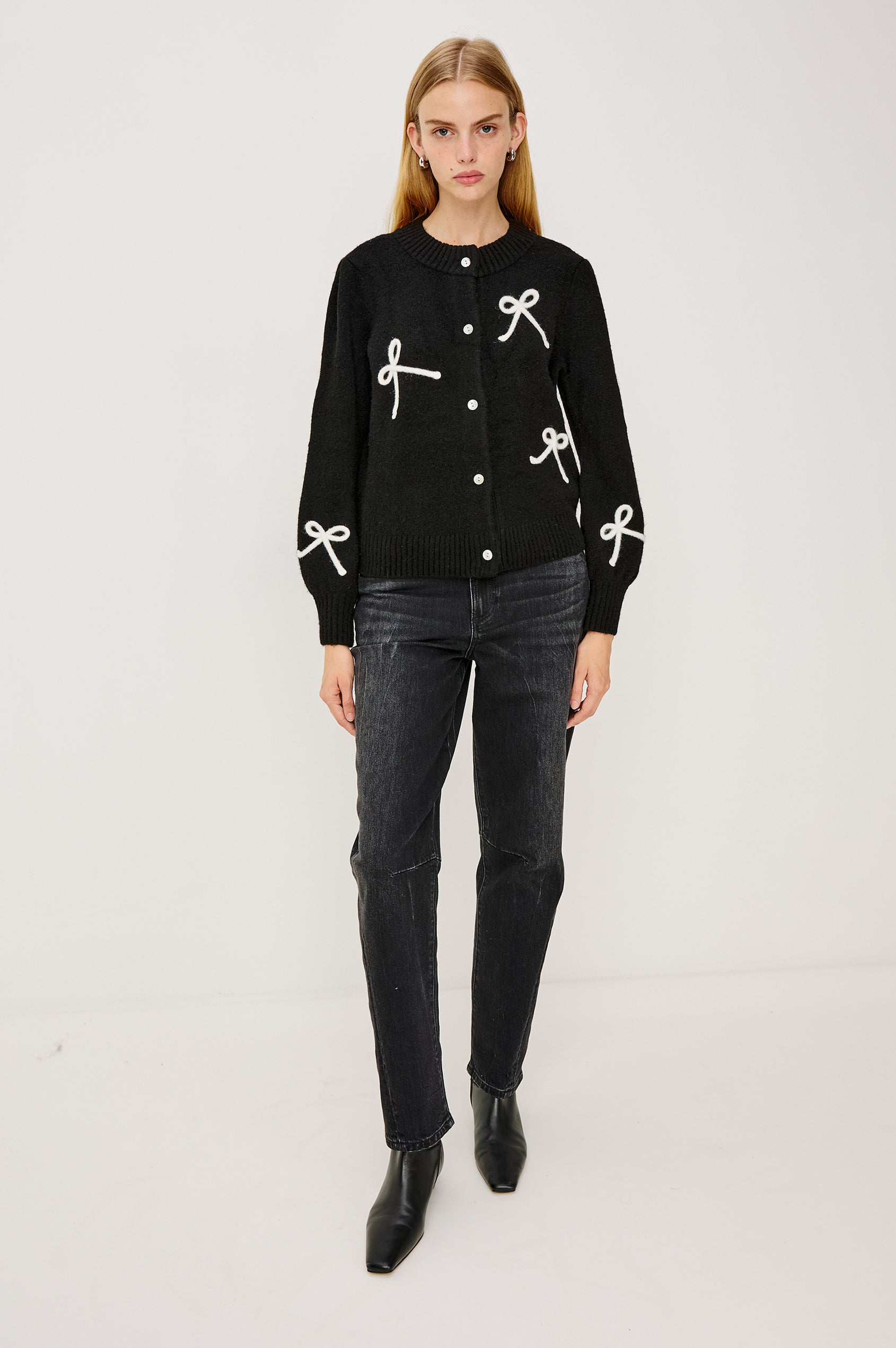Francesca Cardigan in Alpaca Wool Blend With Contrast Soutached Bows, Crew Neckline, Front Buttons, Ribbed Trim, Relaxed Fit, and Long Sleeves in Black Colorway - Full Body Front View Featured on Model
