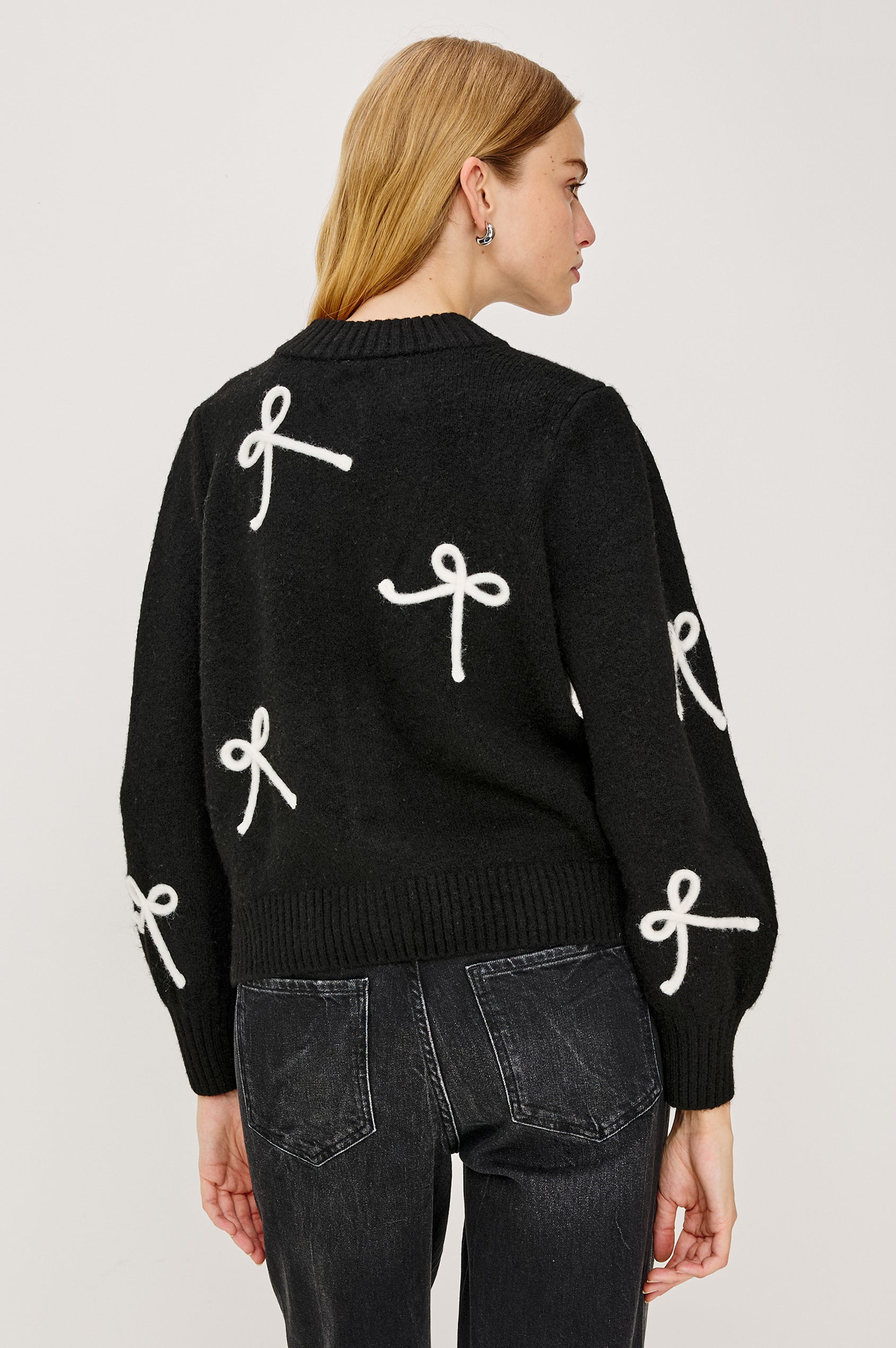 Francesca Cardigan in Alpaca Wool Blend With Contrast Soutached Bows, Crew Neckline, Front Buttons, Ribbed Trim, Relaxed Fit, and Long Sleeves in Black Colorway - Upper Body Back View Featured on Model