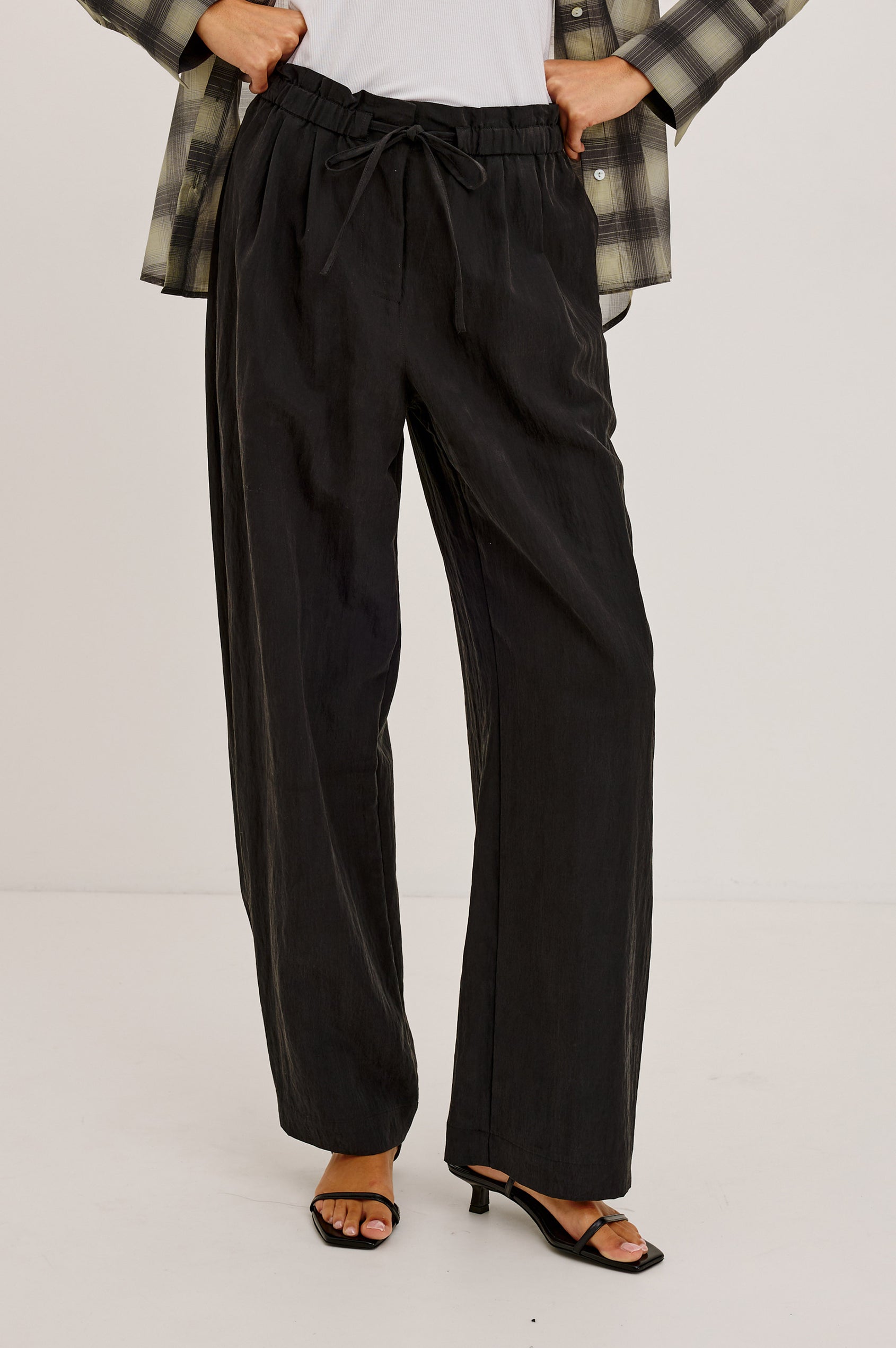 Fulham Pant in Nylon With Mid-Rise Wide Leg Fit, Front Pleats, Back Patch Pockets, Back Hem Buttons to Adjust Leg Wide to Slim in Black Colorway - Lower Body Front View Featured on Model