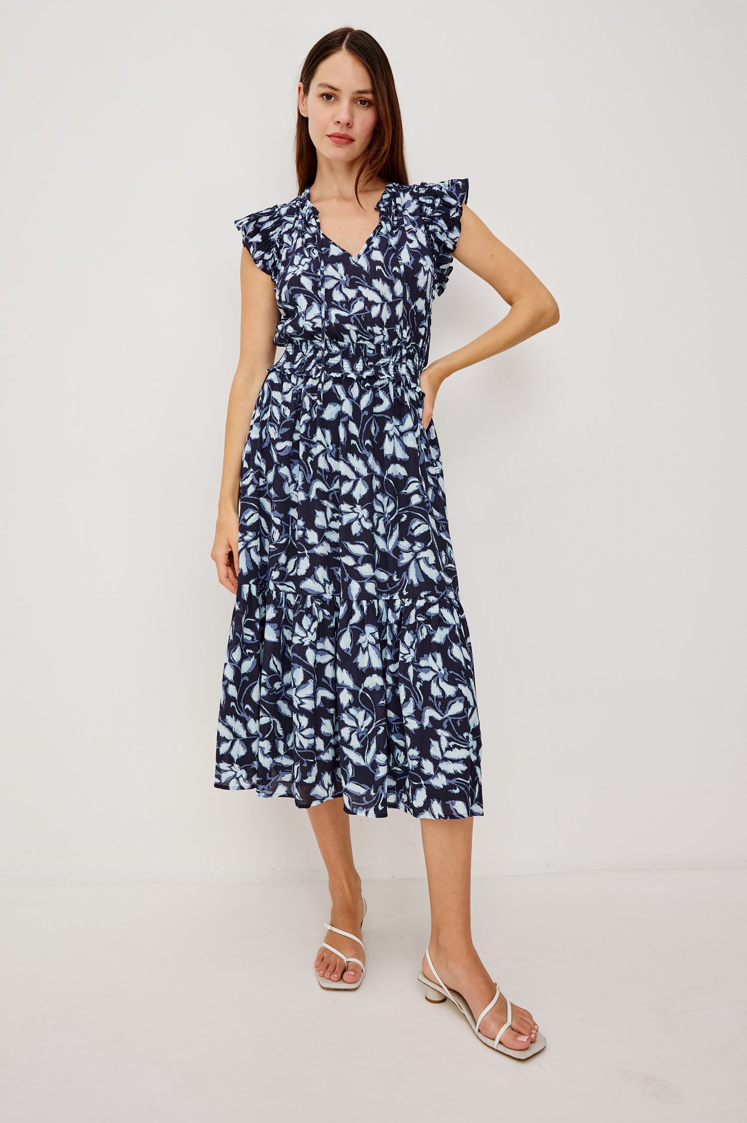 Garden Peasant Floral Midi Dress in Linen With Ruffle Flutter Sleeves, Center Front Ties, V-Neckline, Shirred Waist, and Relaxed Fit in Navy Jasmine Colorway - Full Body Front View Featured on Model