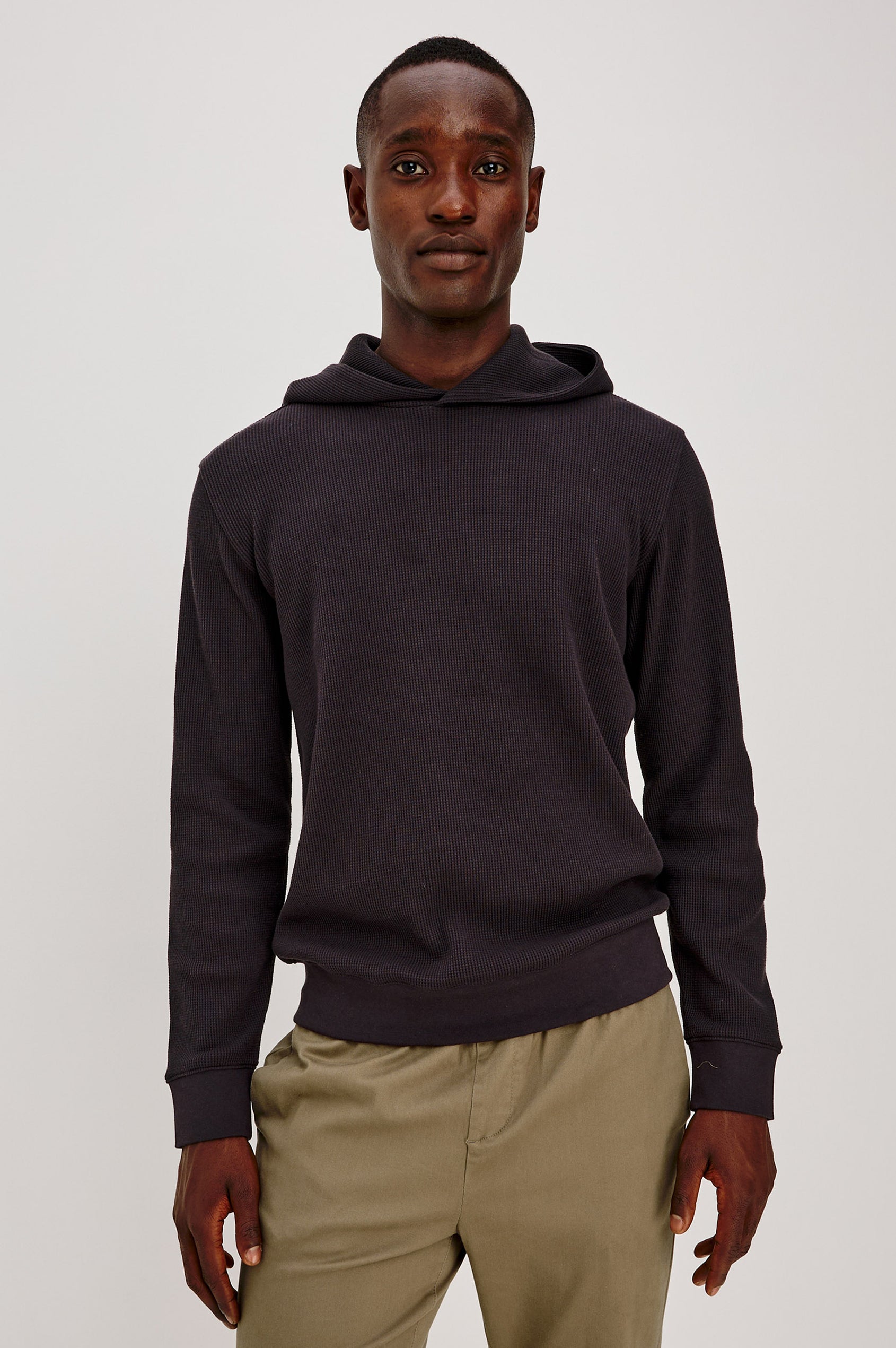 Gates Hoodie in Micro-Waffle Cotton Blend With Fixed Hood, Long Sleeves, and Relaxed Fit in Onyx Colorway - Upper Body Front View Featured on Model